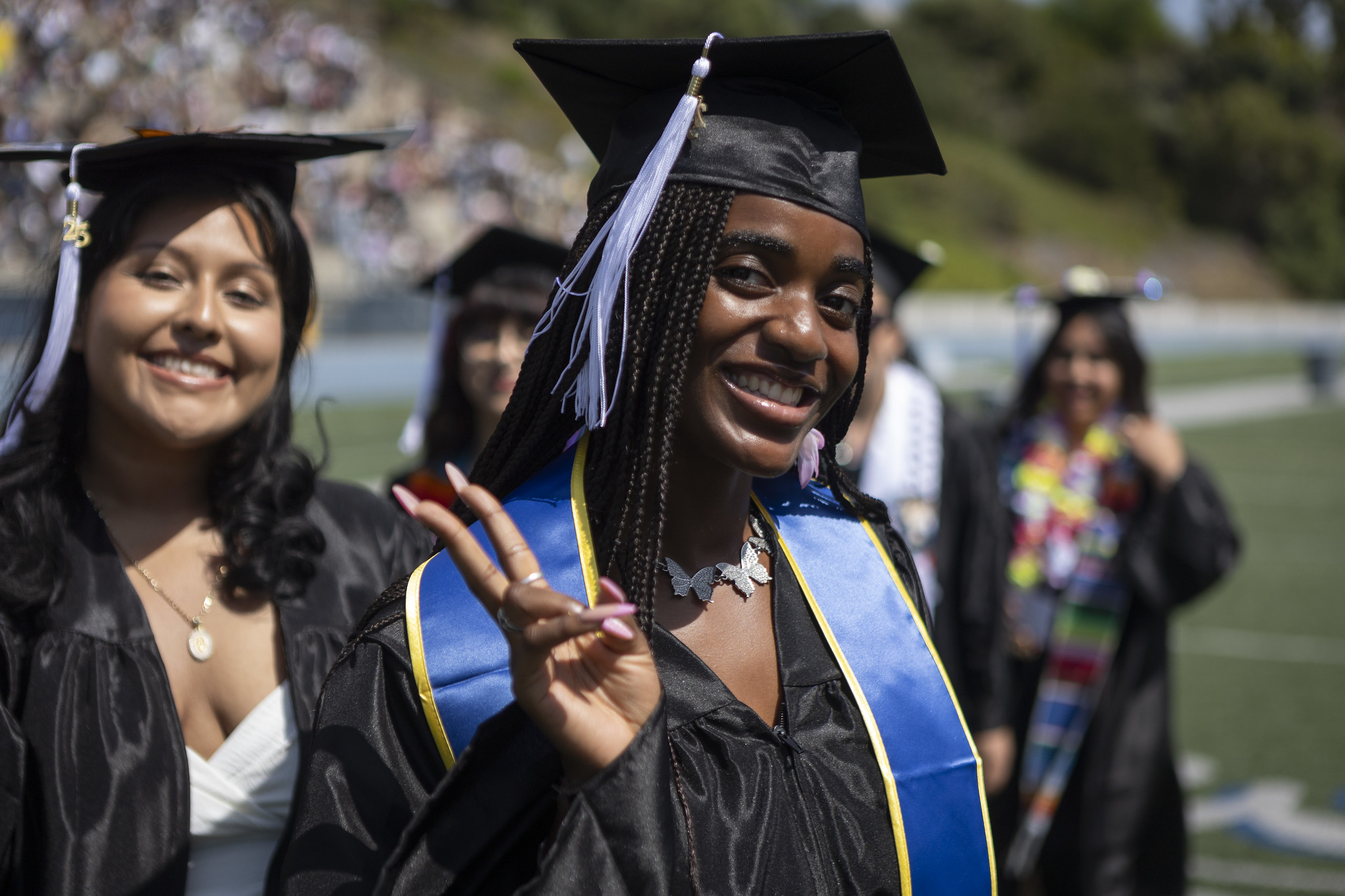 
A graduate gives a peace sign.
