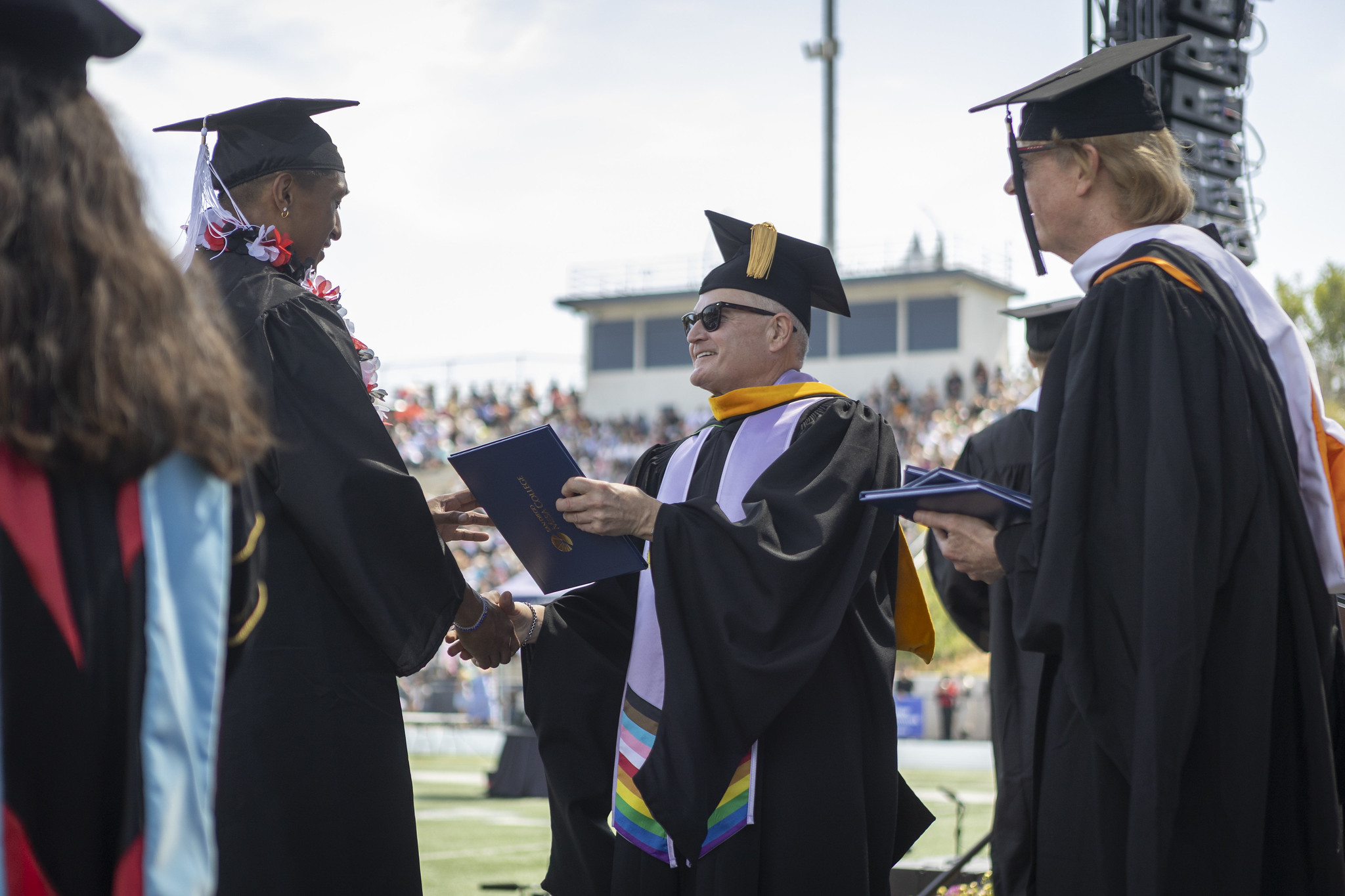 
Trustee Craig Milgrim hands a graduate a diploma.
