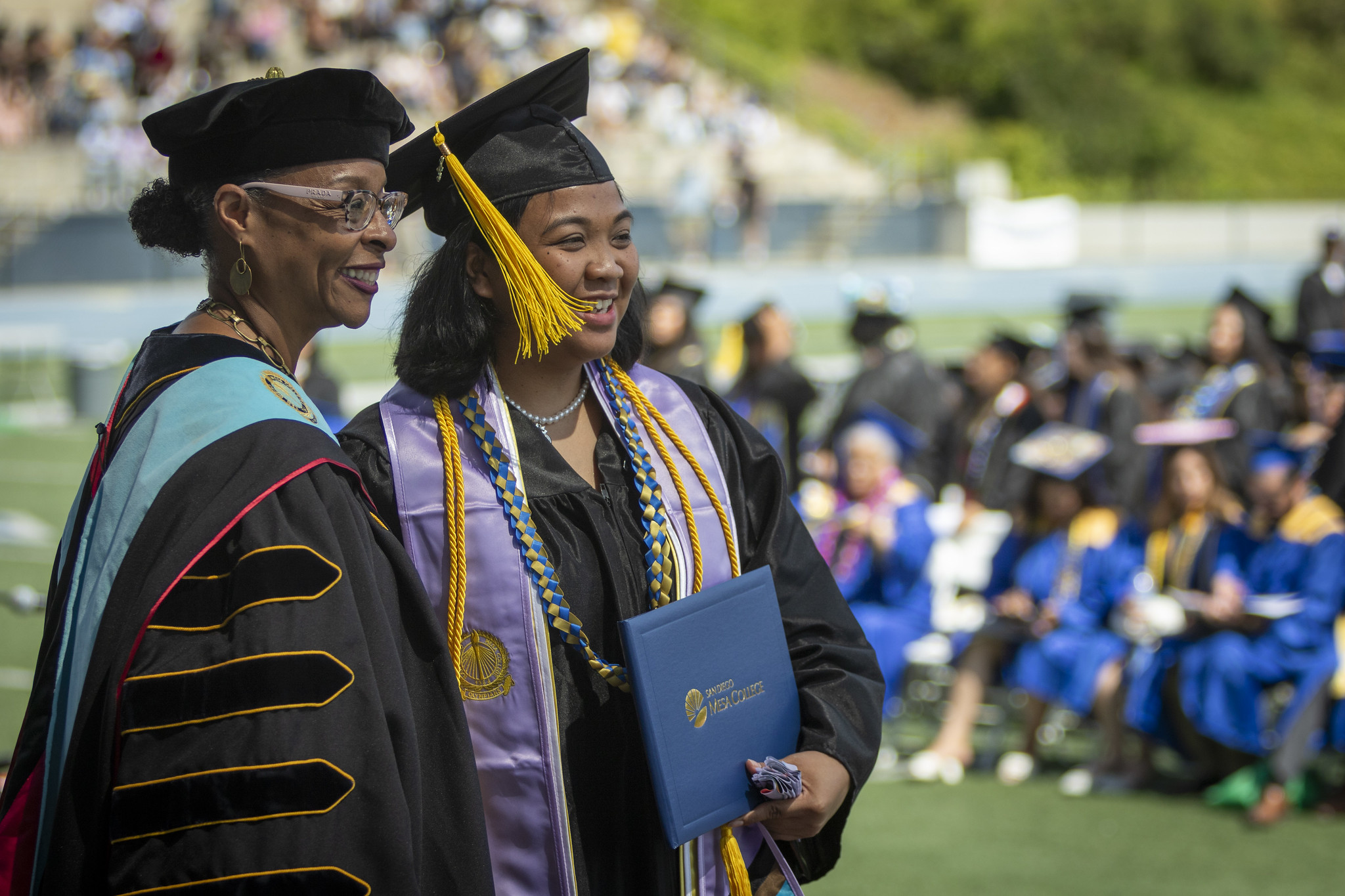
Mesa College President Ashanti Hands with a graduate who just received her diploma.
