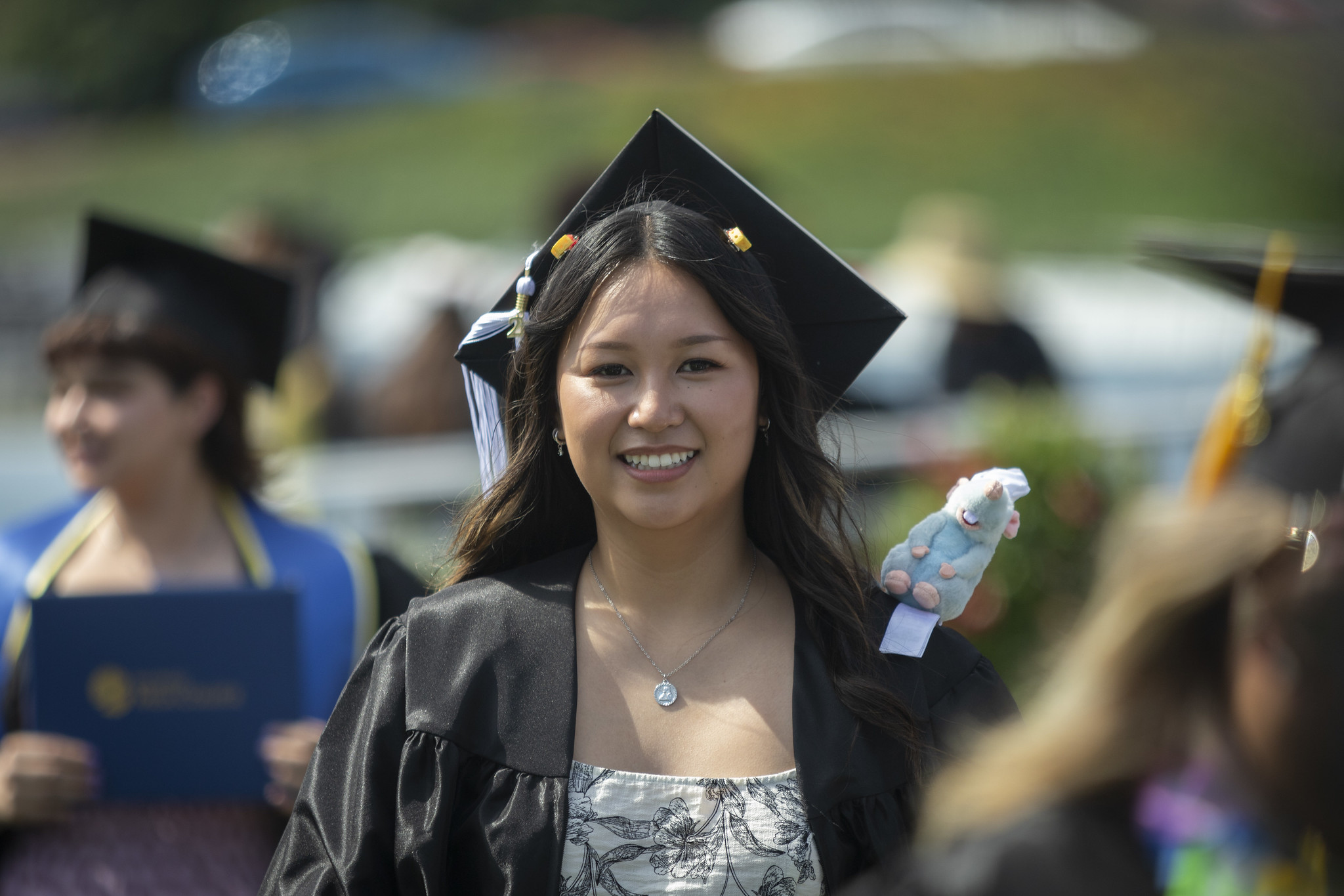 
A graduate smiling in the crowd.
