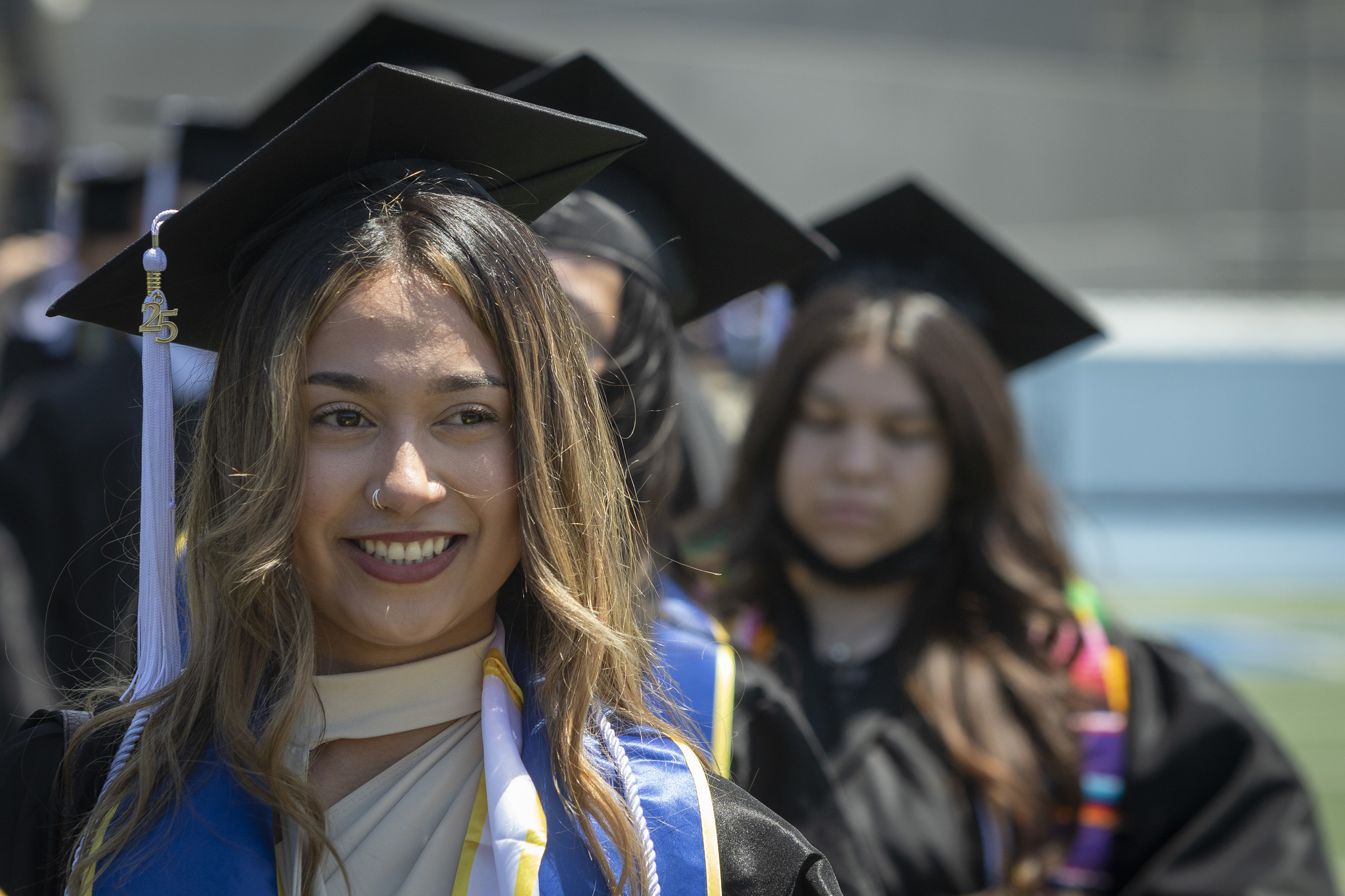 
A graduate walks to her seat.
