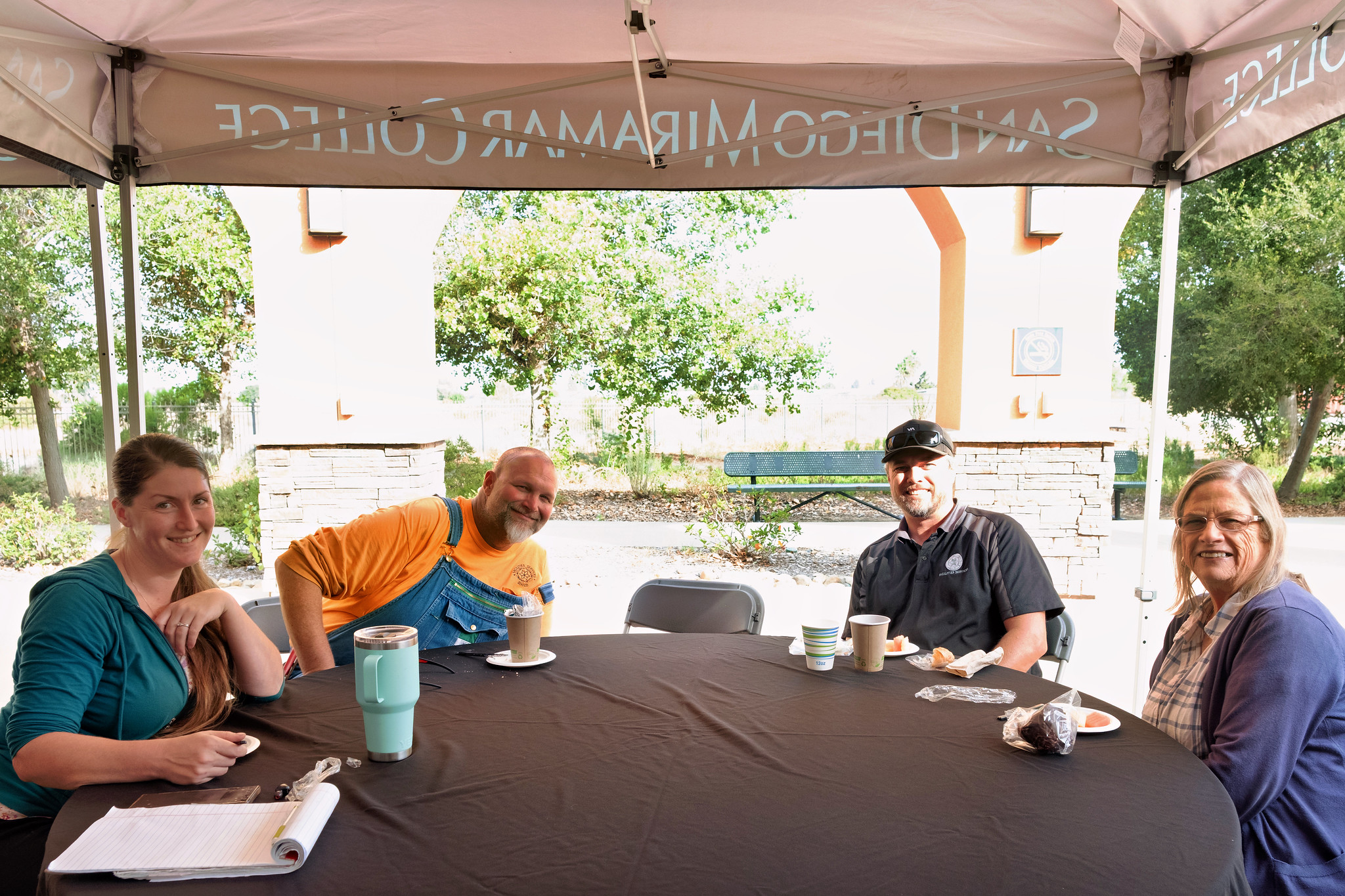 
Four people at a table for lunch at convocation.
