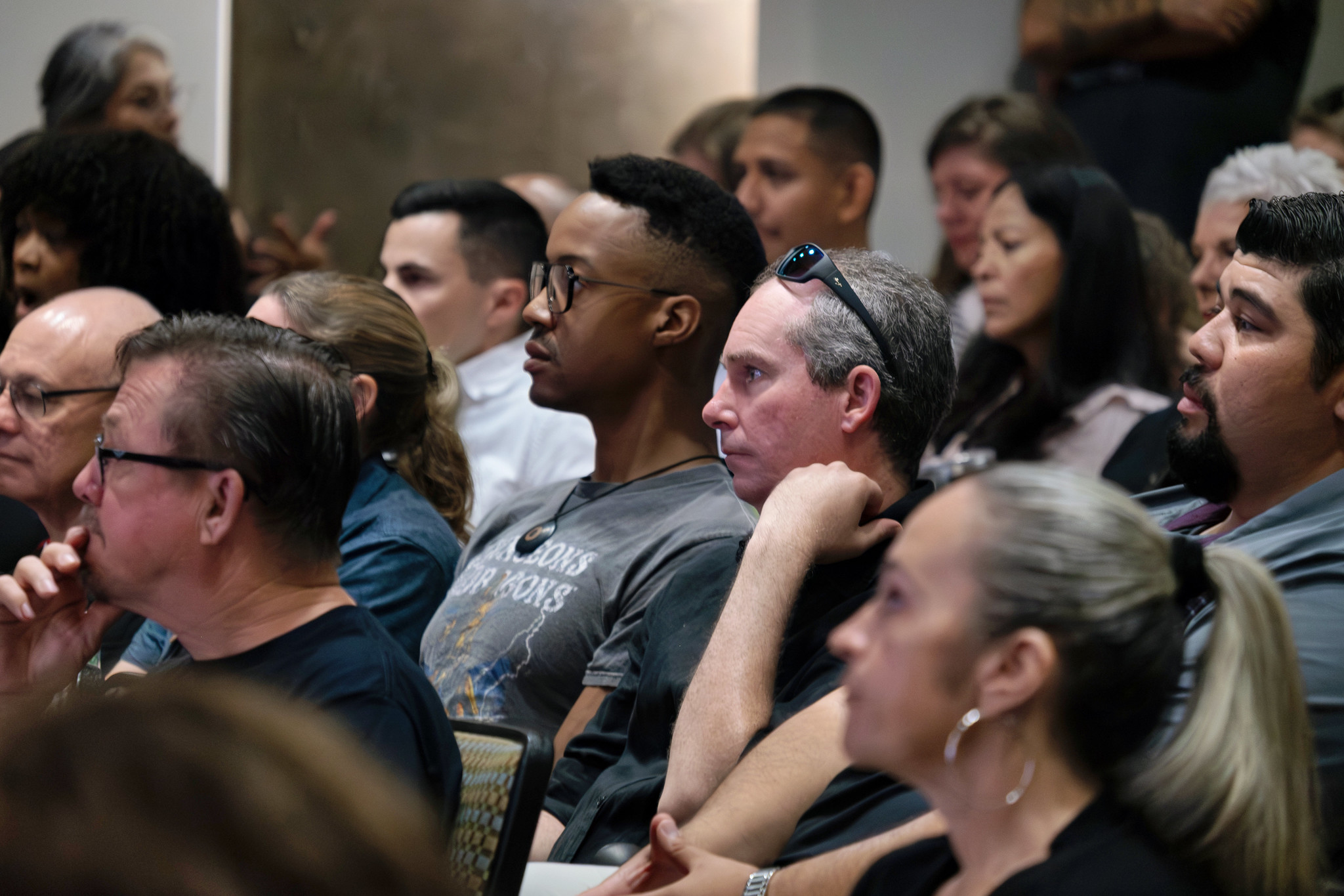 
The audience watches the presentation.
