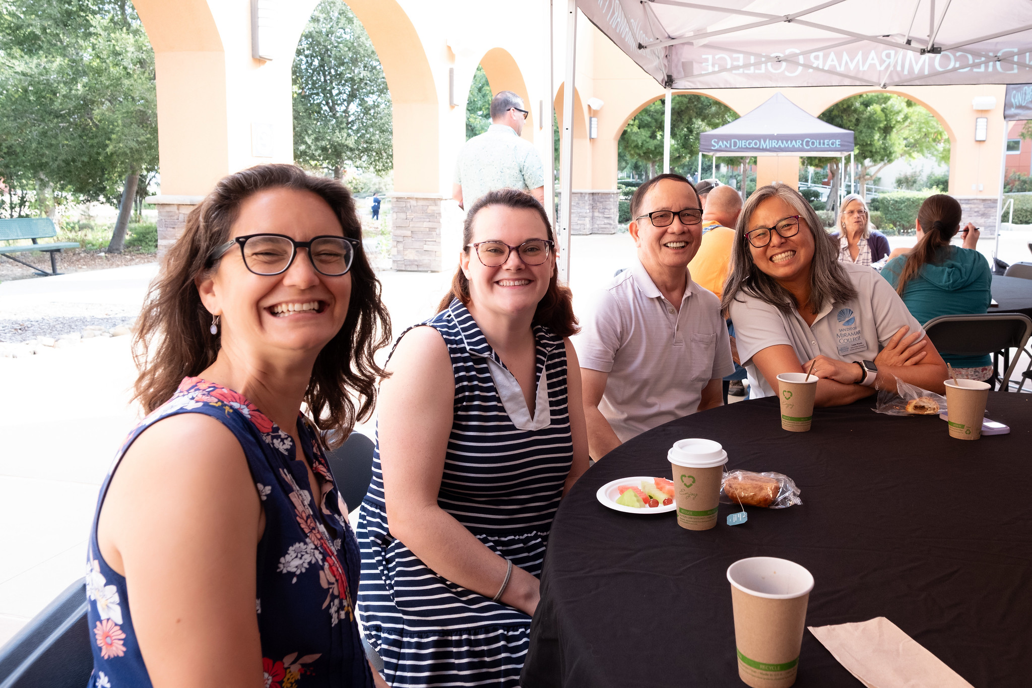 
Four people at a table for lunch at convocation.
