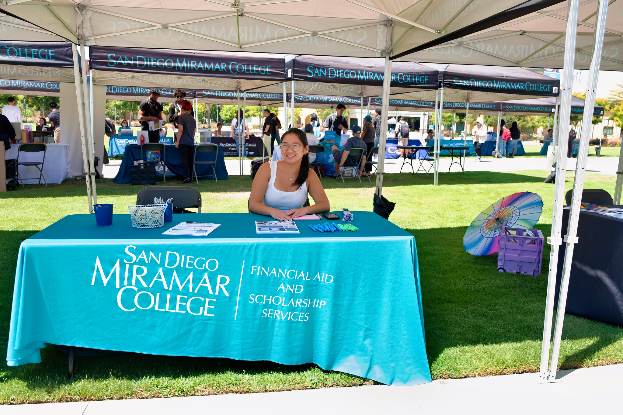 
A woman working the financial aid information booth.
