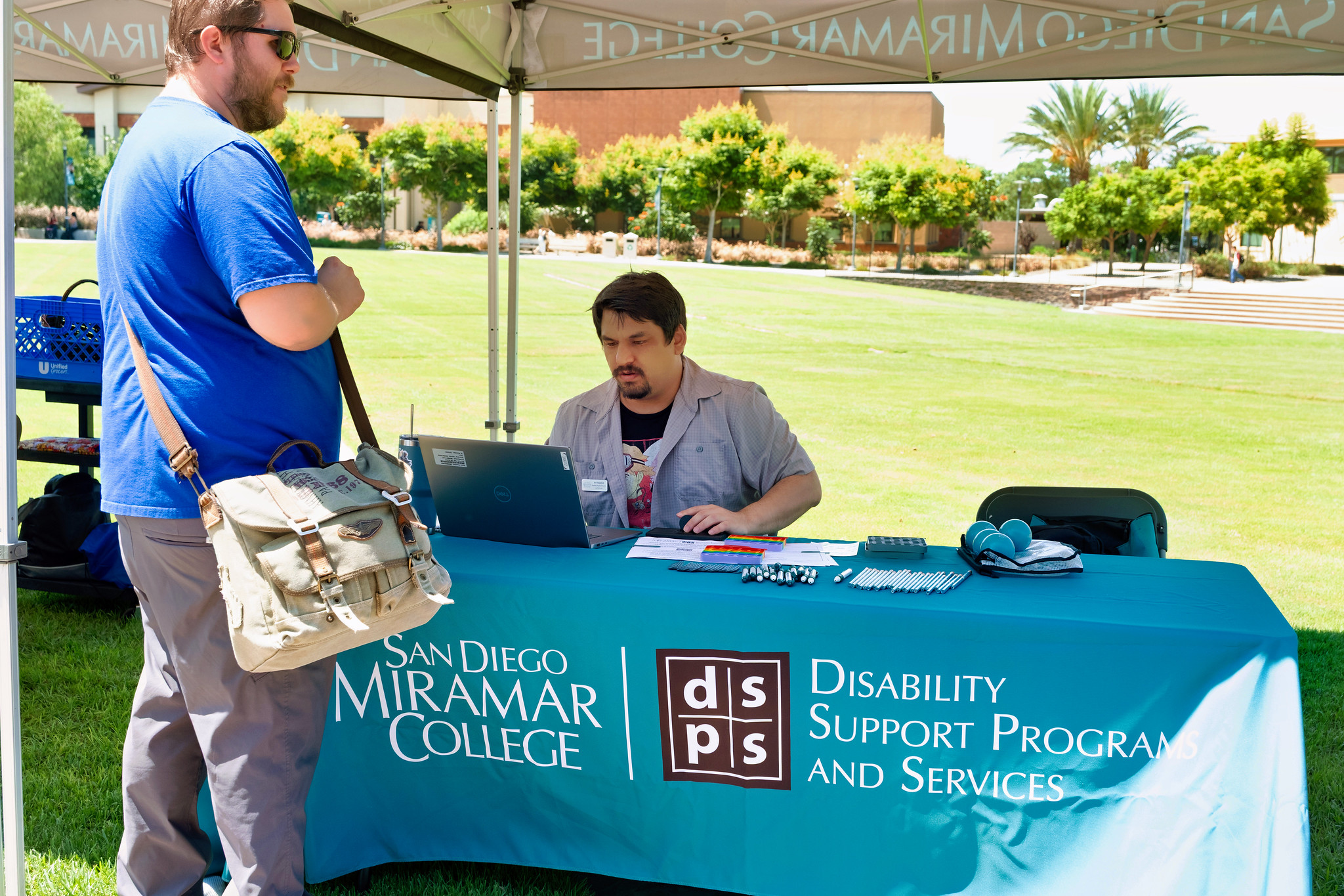 
A student stops by the booth for disability support programs and services.

