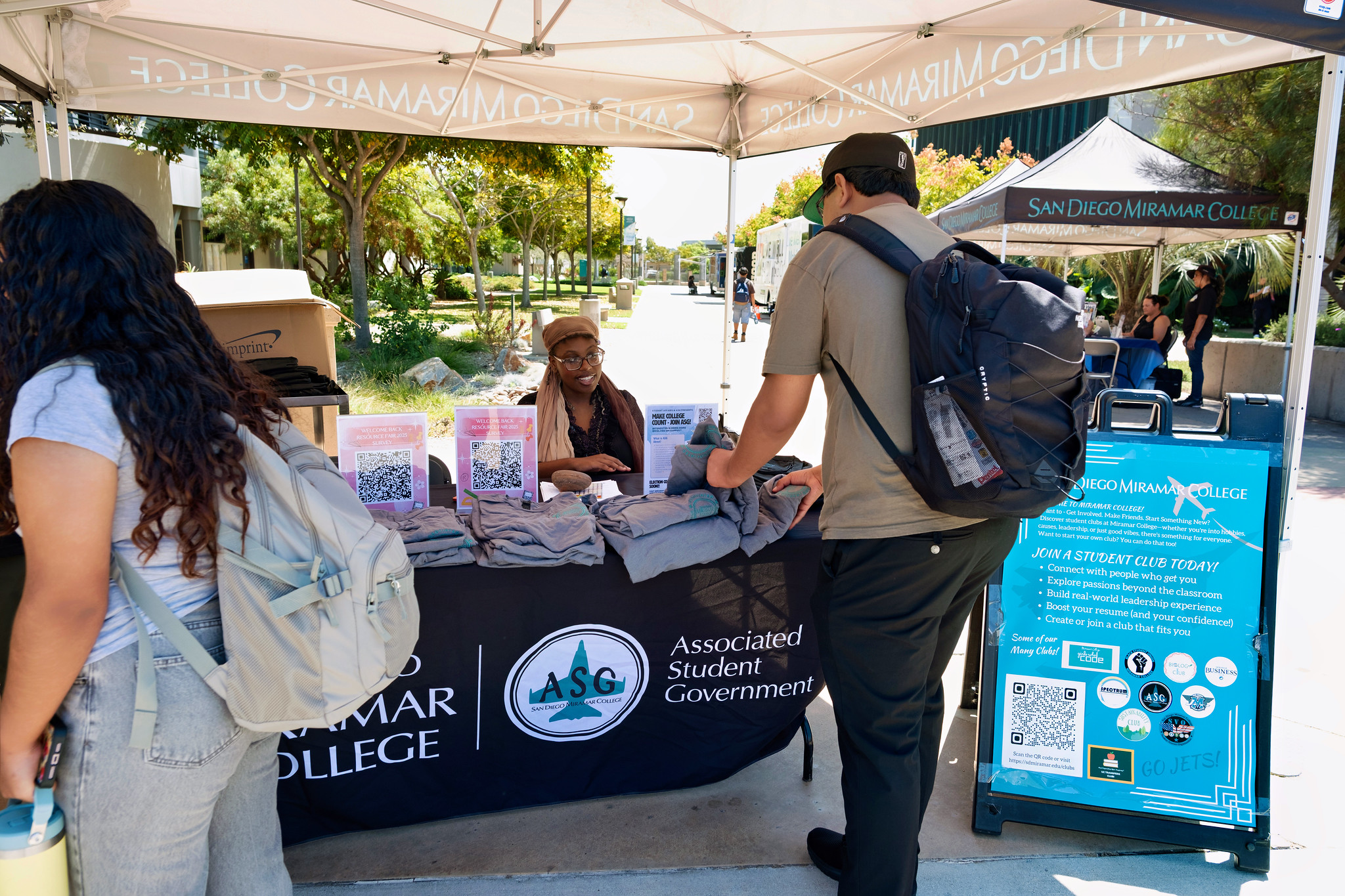 
A student looks through t-shirts at the Associated Student Government booth.&nbsp;
