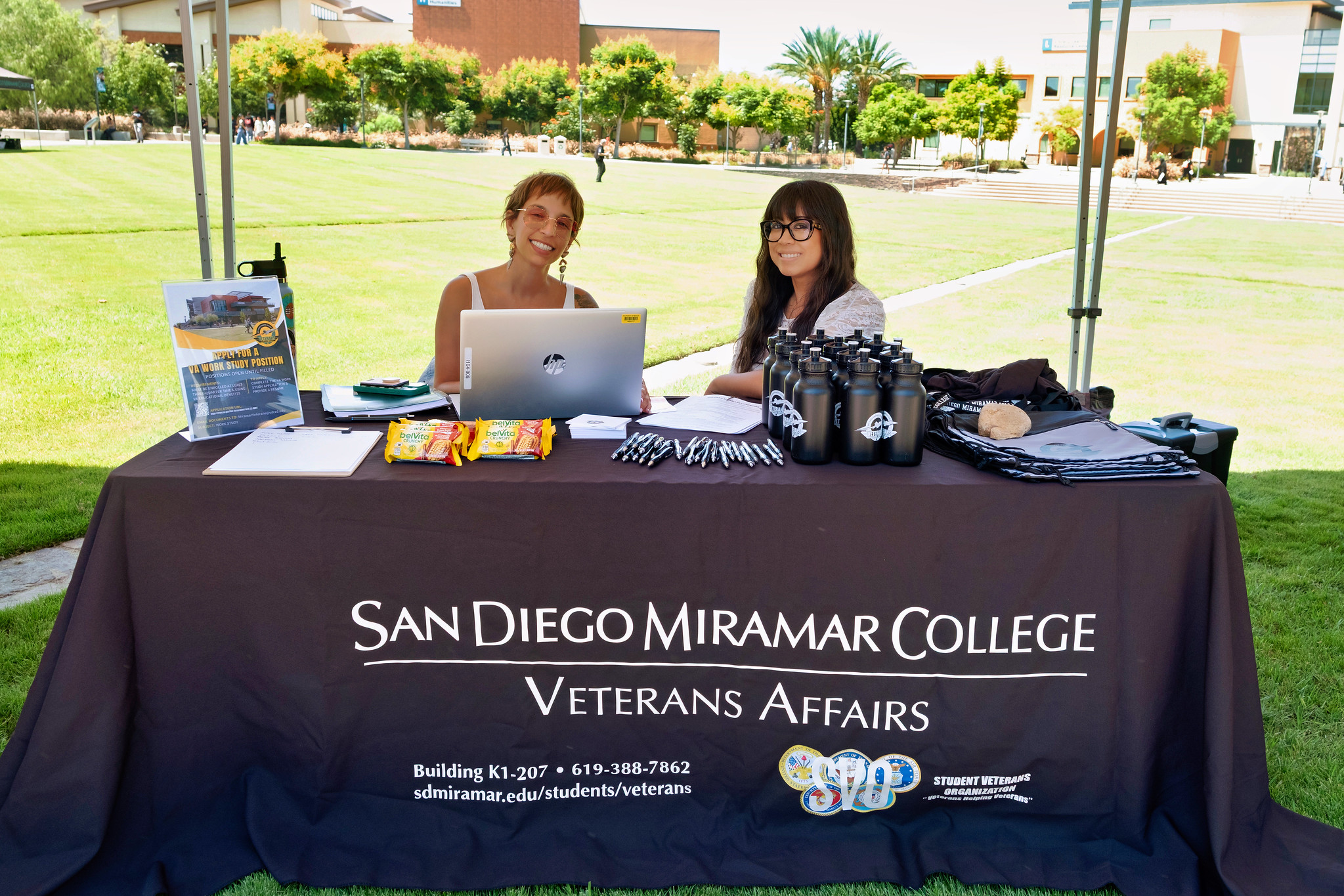 
Two people working at the Veterans affairs booth.&nbsp;
