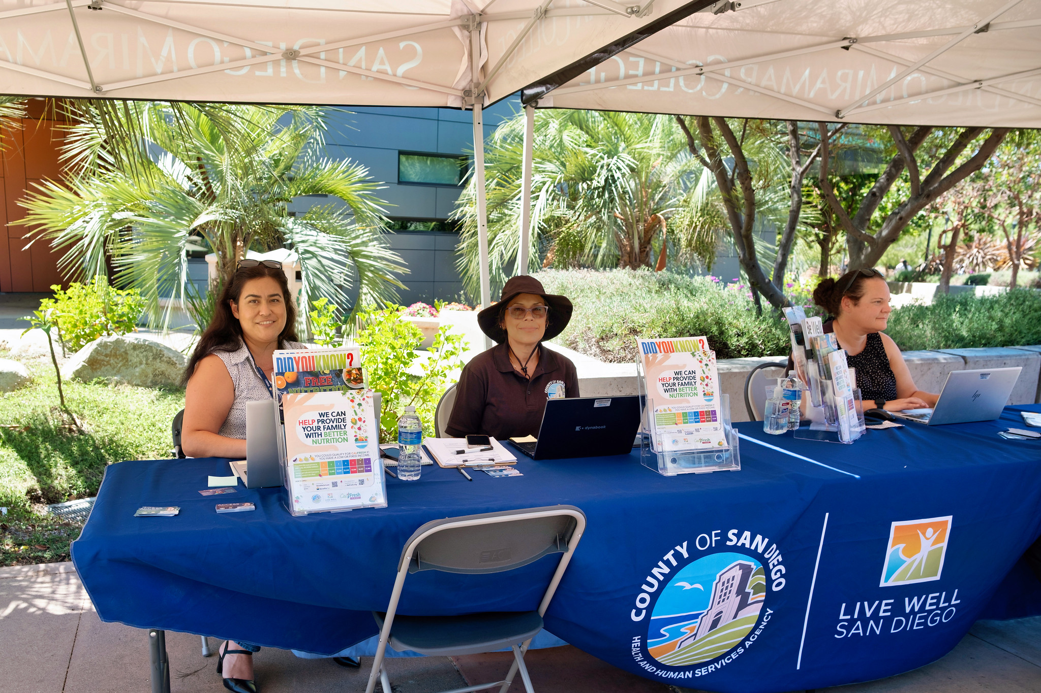 
Three women working at the County of San Diego booth.
