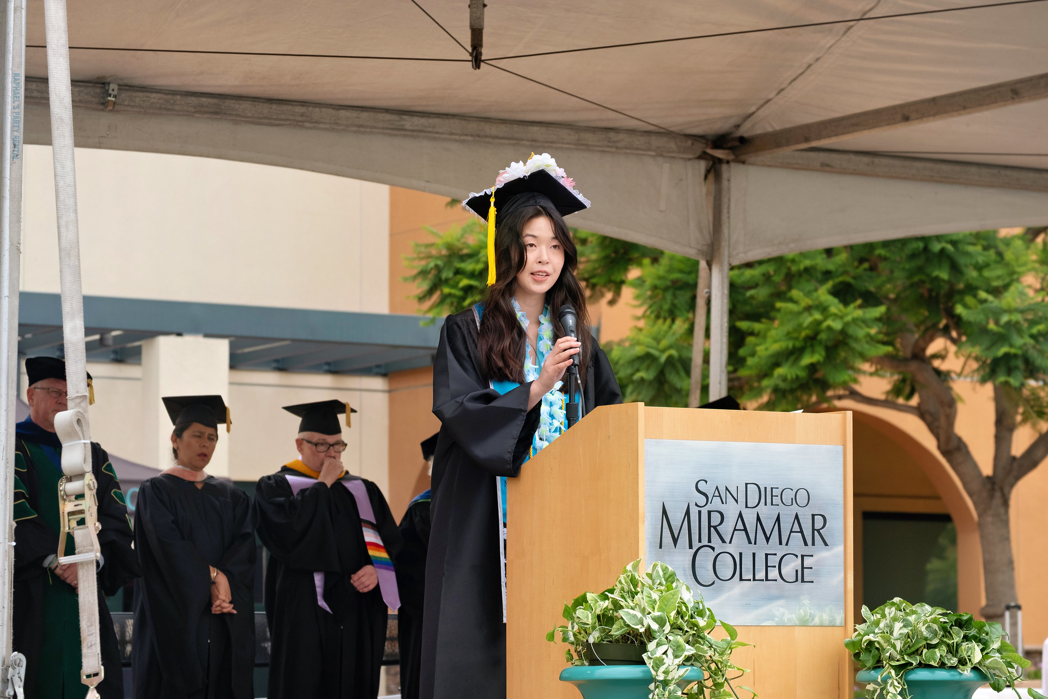
Associated Student President Hailey Hua speaking at a podium during commencement.
