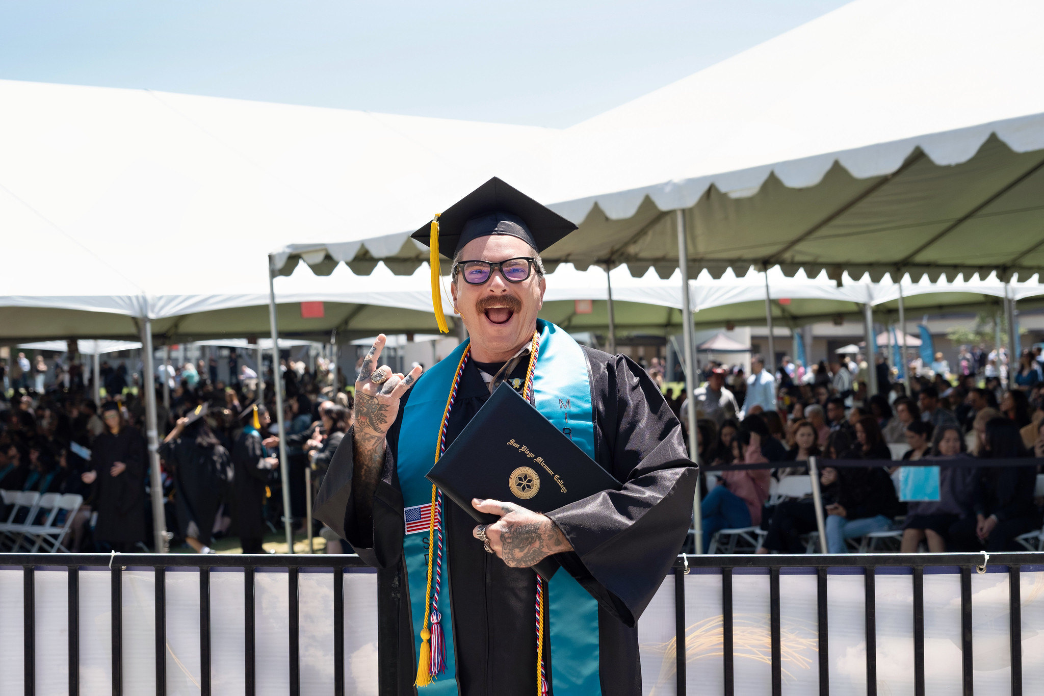 
A graduate holds up his degree.
