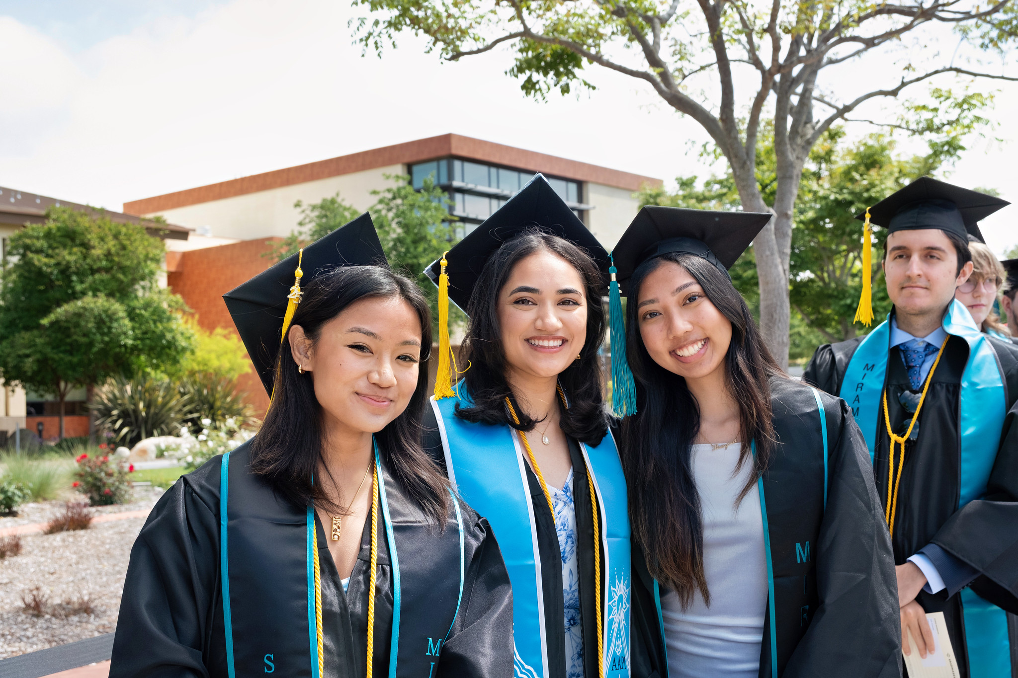 
Four graduates lined up to walk into commencement.
