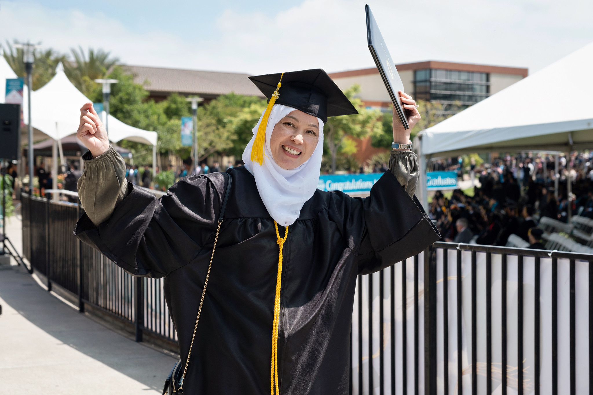 
A graduate holds up her degree.
