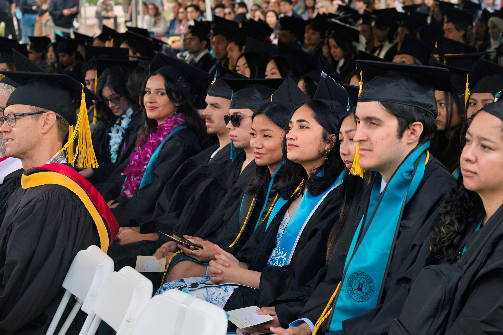 
A group of graduates seated during commencement.

