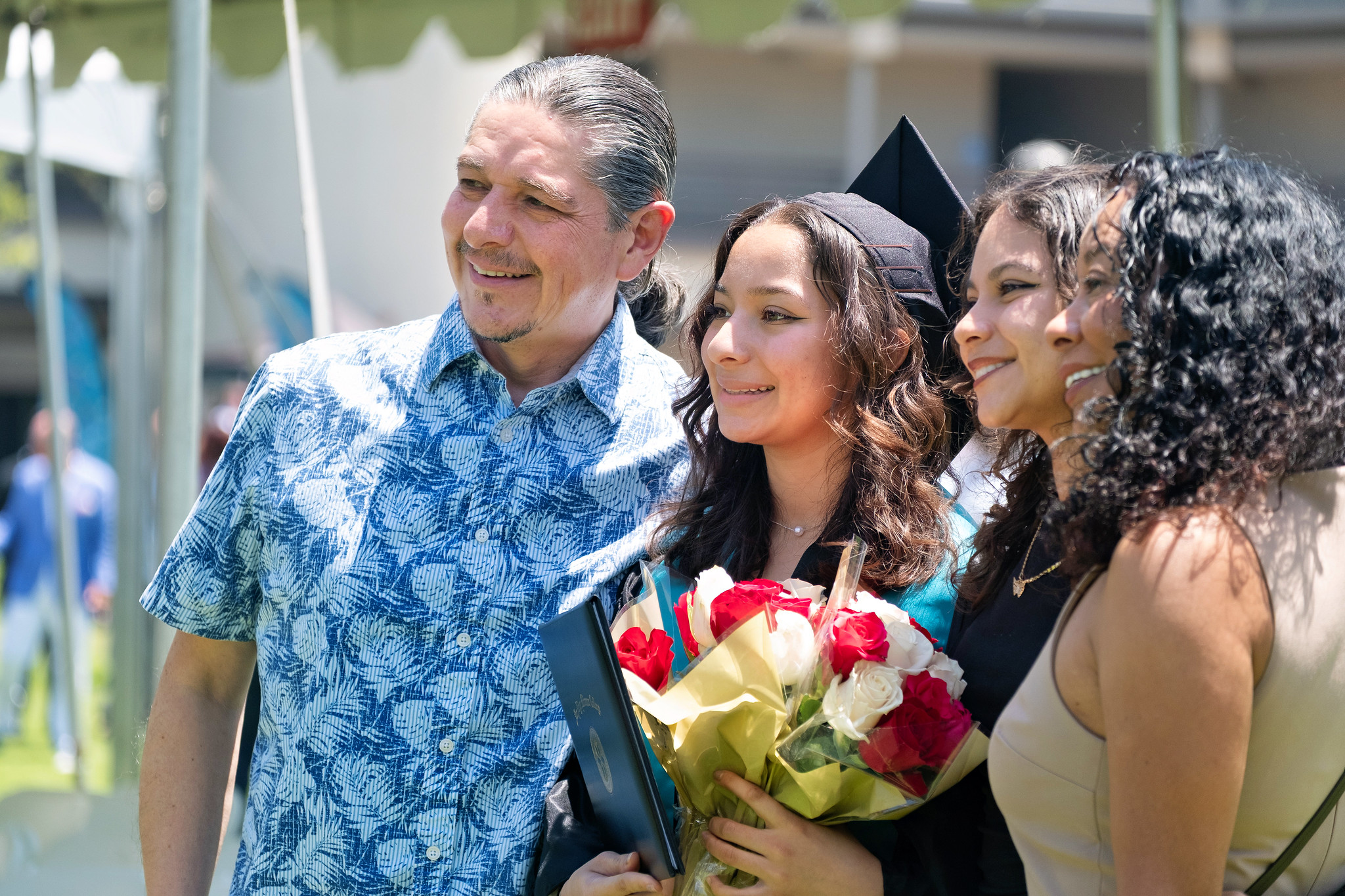 
A graduate takes a photo with three family members.

