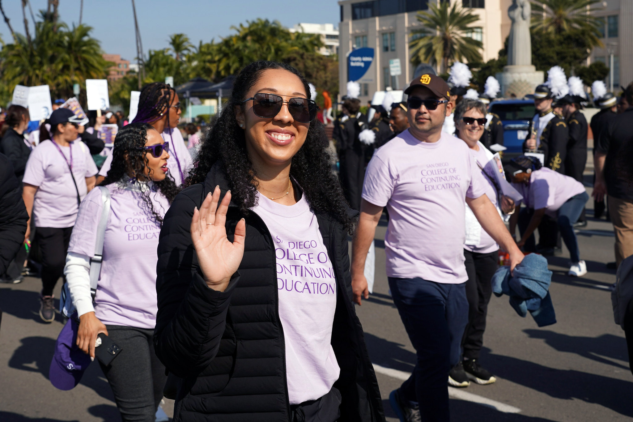 Public Information Officer Brenna Leone Sandeford waves while walking in the parade.