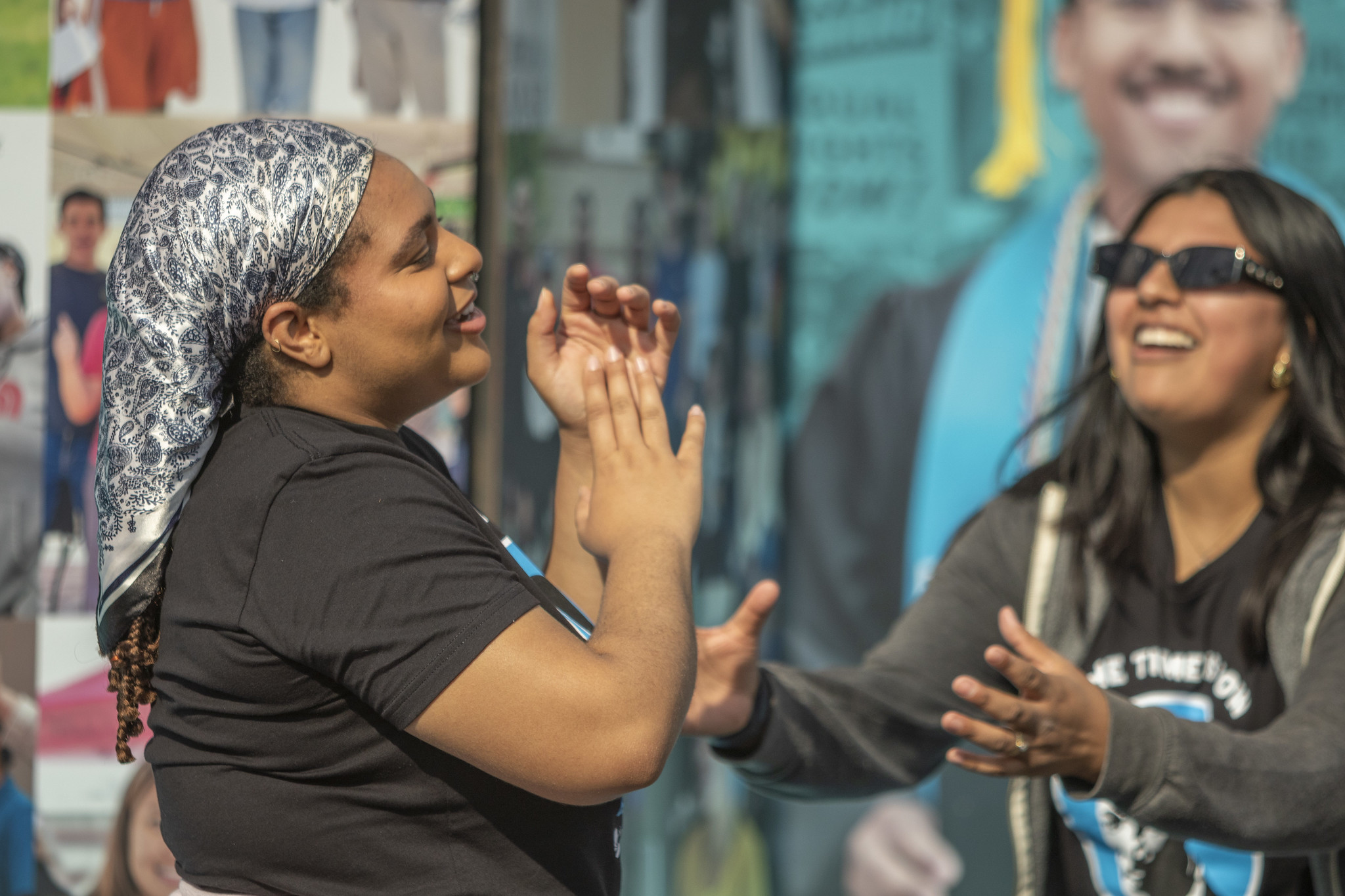 Student trustees Zora Williams and Dahlia Ramirez sing along with the music.