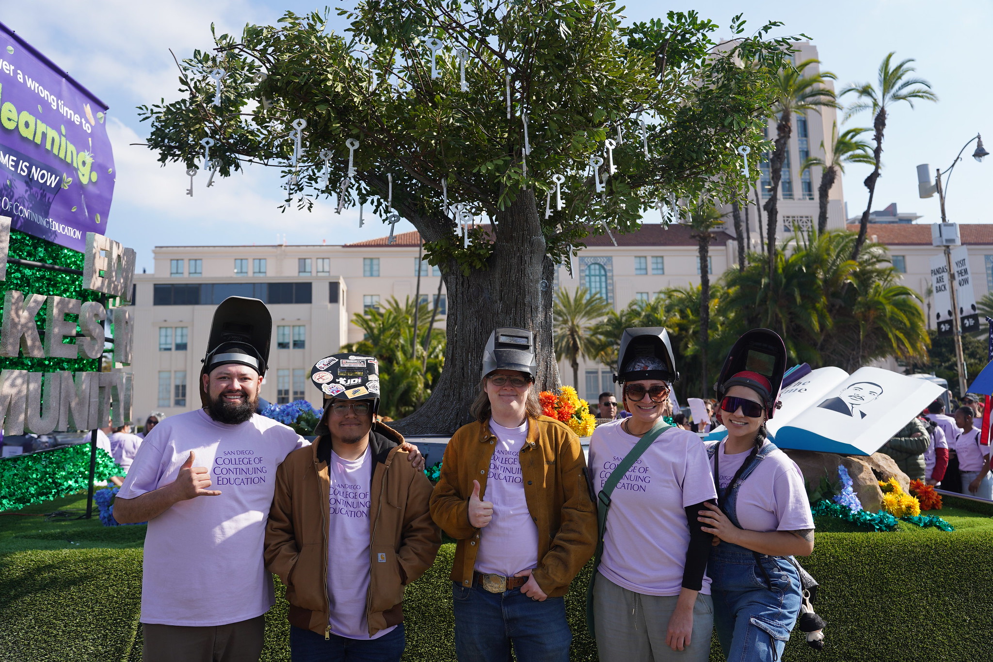 Five welding students in front of the float the helped create.