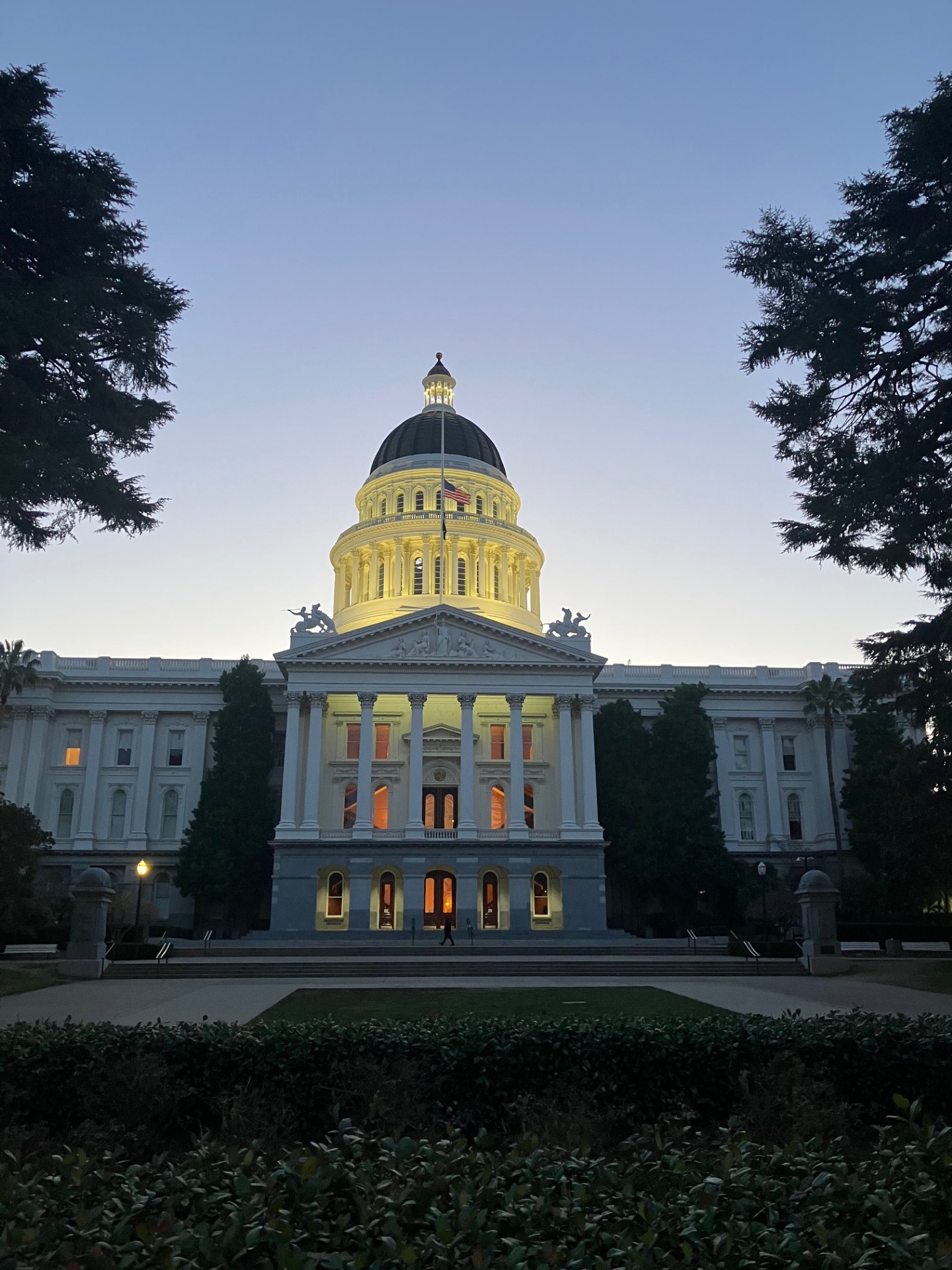 
The outside of the Capitol building in Sacramento lit up at night.

