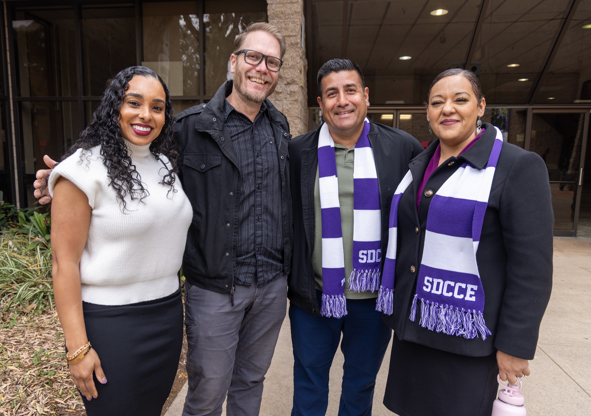 
College of Continuing Education President Tina King with three employees at the Educational Cultural Complex.
