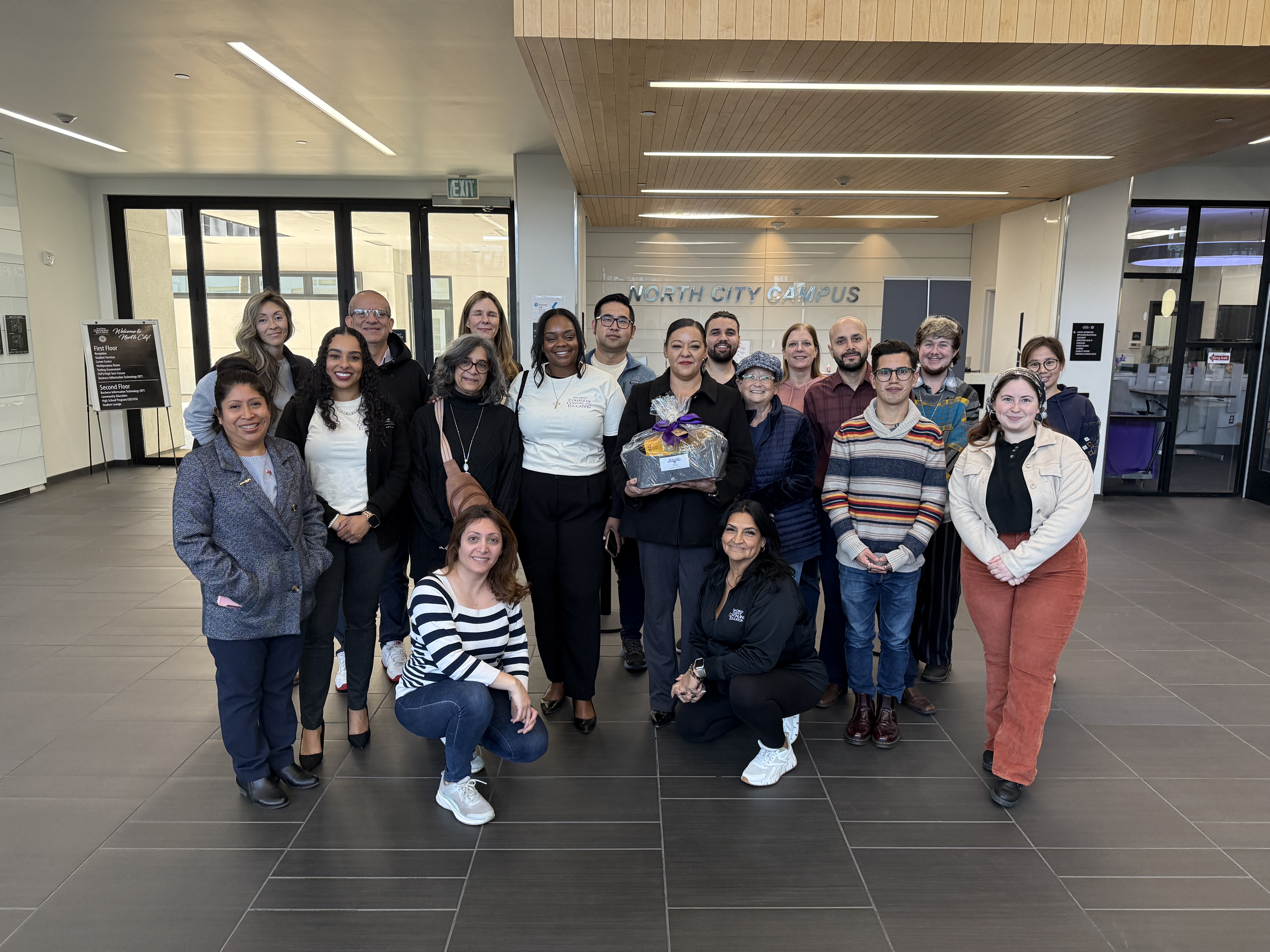
College of Continuing Education President Tina King gives a welcome basket to 18 employees at one of the college's campuses.
