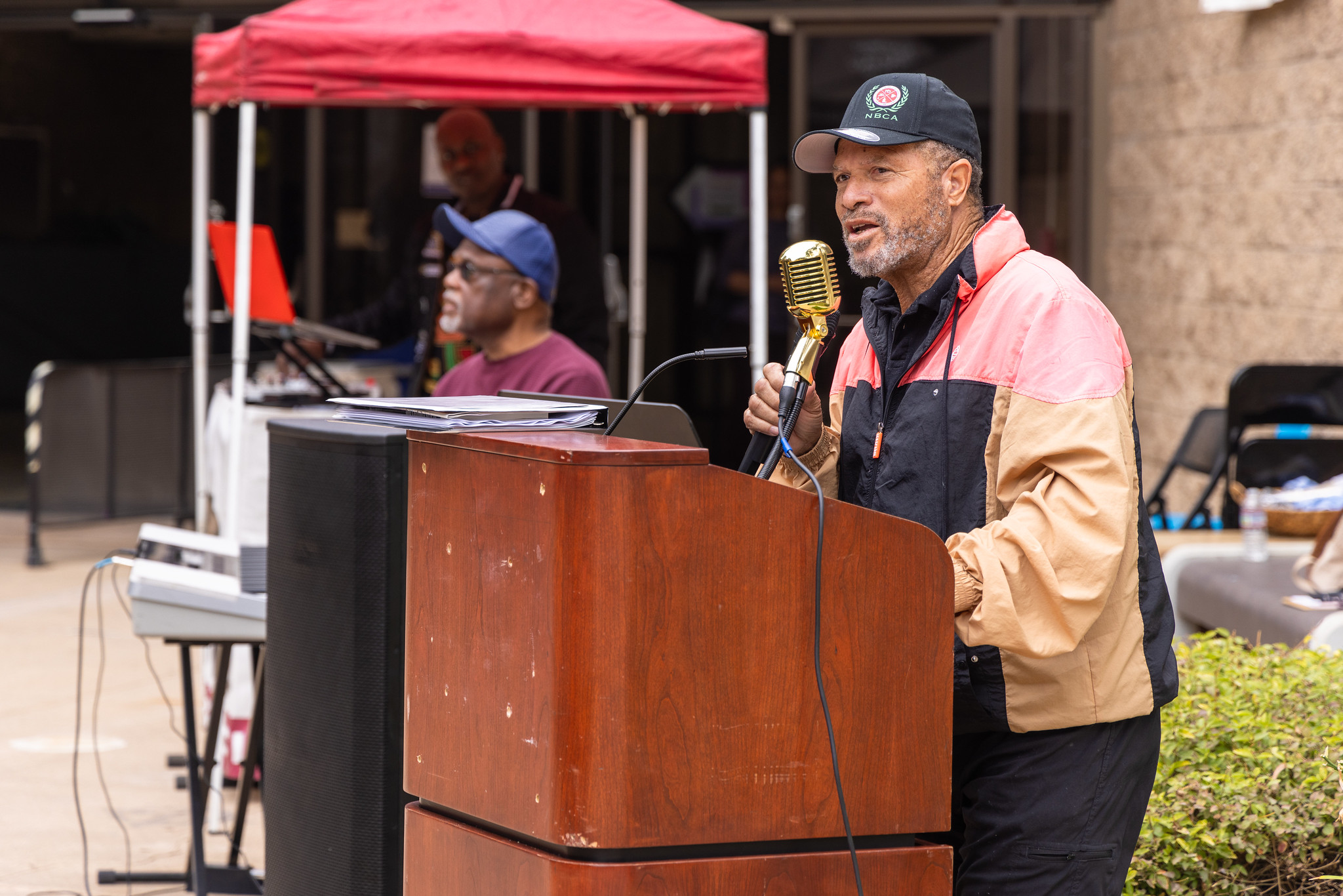 
A man speaks at a podium during a Black History Month event at the Educational Cultural Complex.
