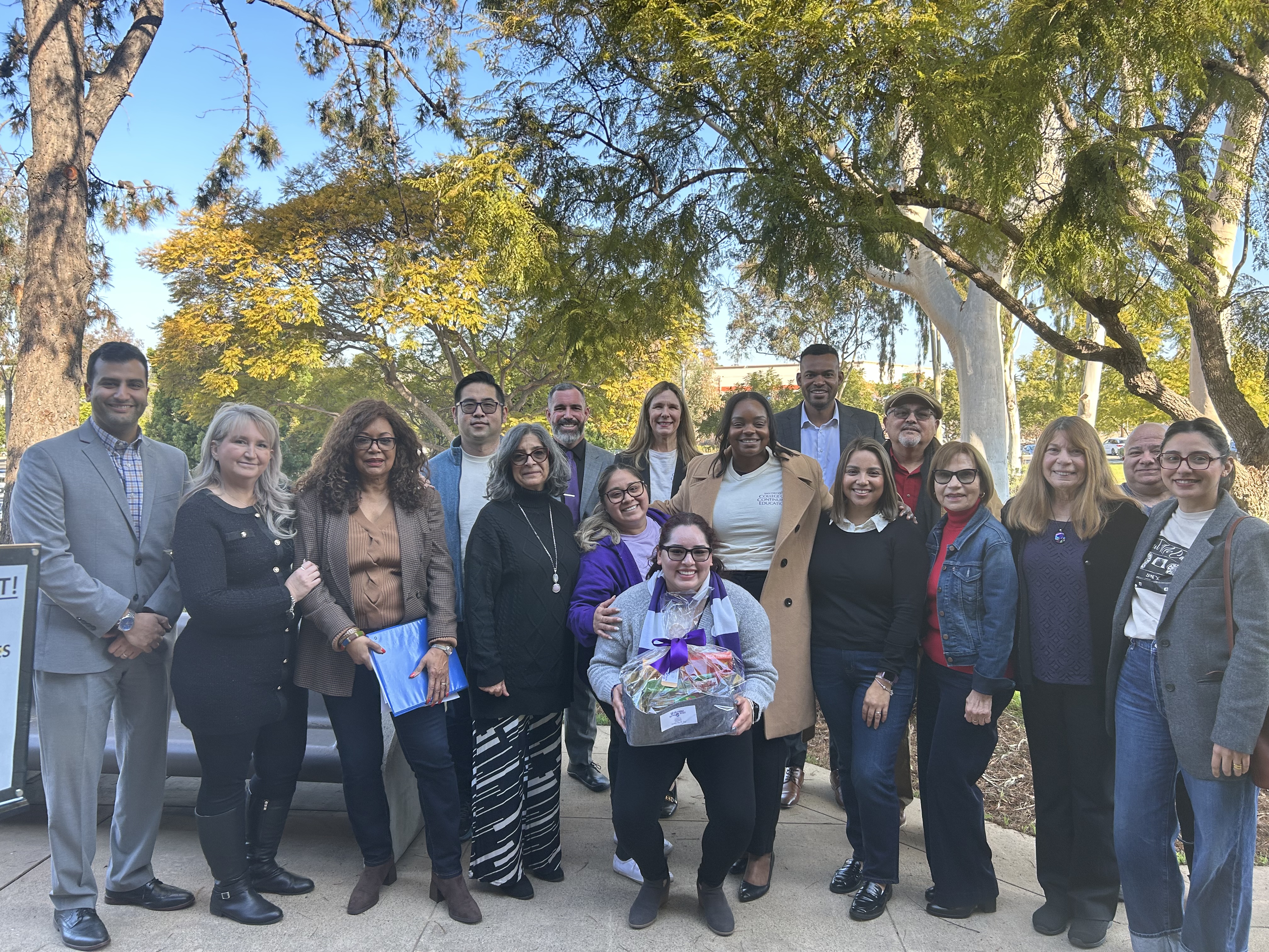 
College of Continuing Education President Tina King gives a welcome basket to 17 employees at one of the college's seven campuses.
