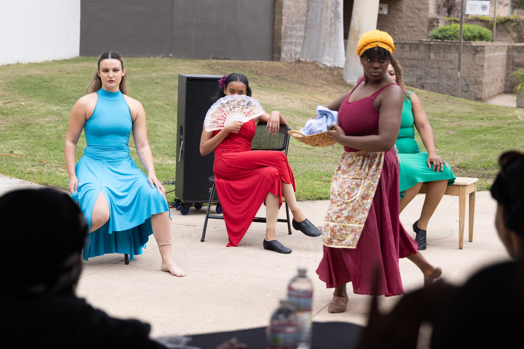 
Four women in colorful dresses perform a dance during a College of Continuing Education Black History Month event.
