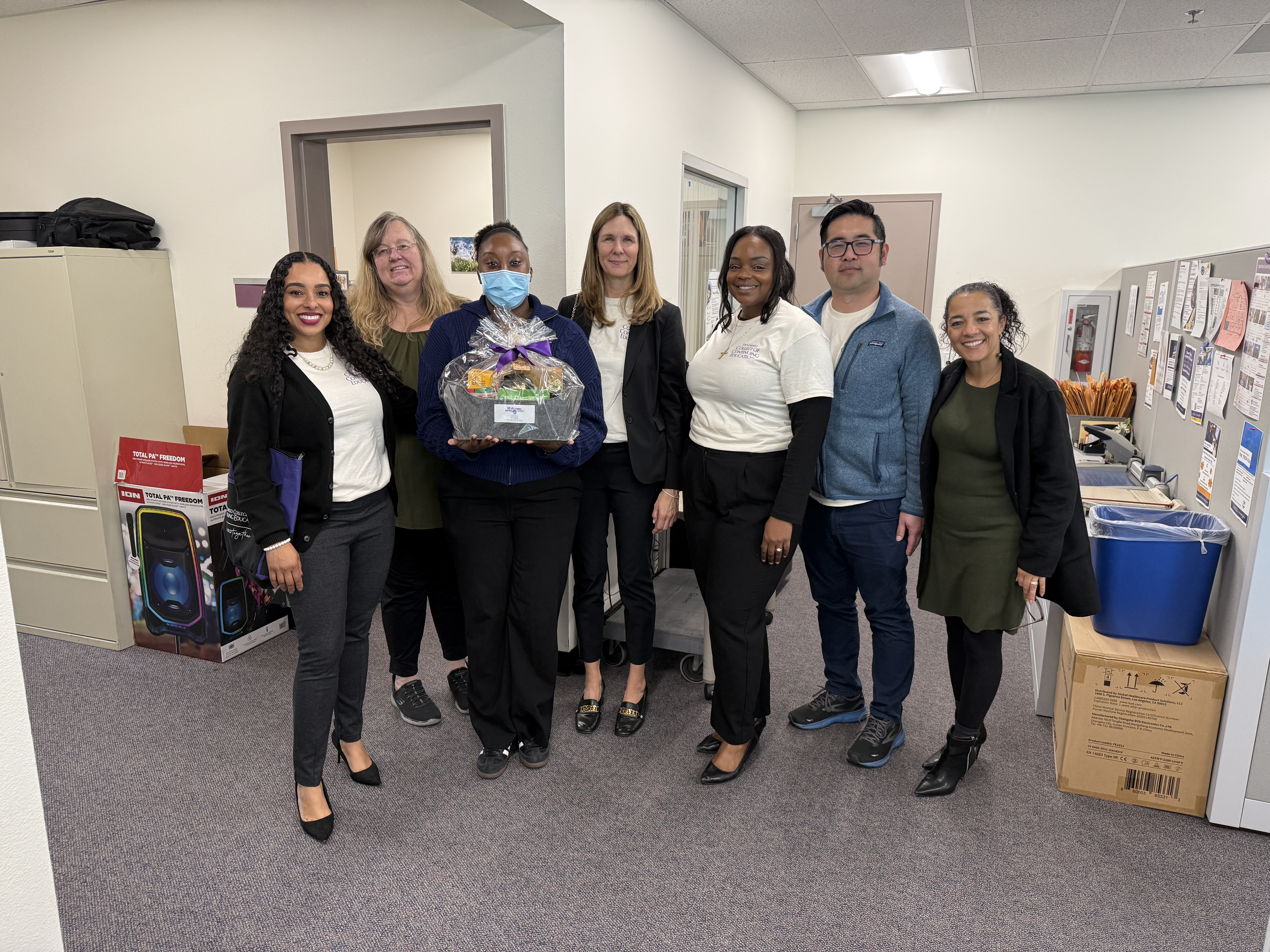 
College of Continuing Education President Tina King gives a welcome basket to 6 employees at one of the college's seven campuses.
