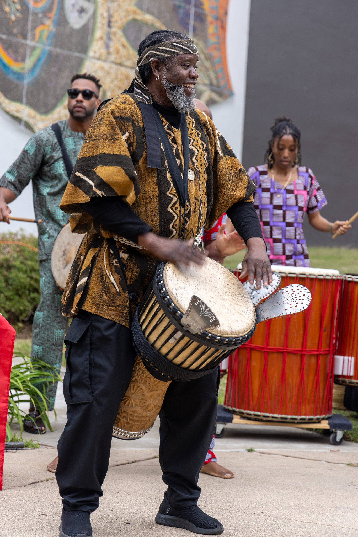 
A drummer in a black and brown smock and matching headband performs at a Black History Month event at ECC.
