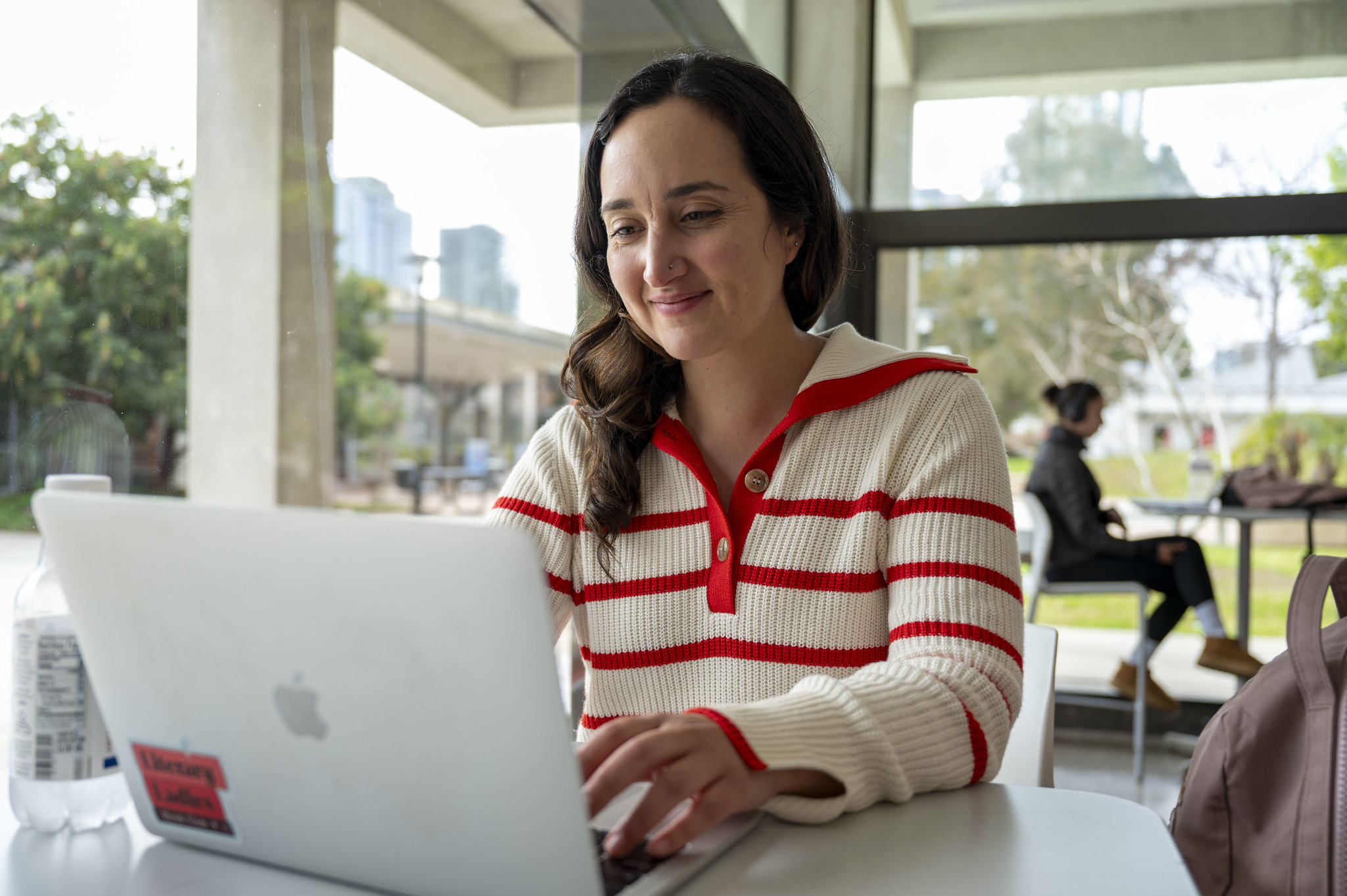 
A City College student working on a laptop.
