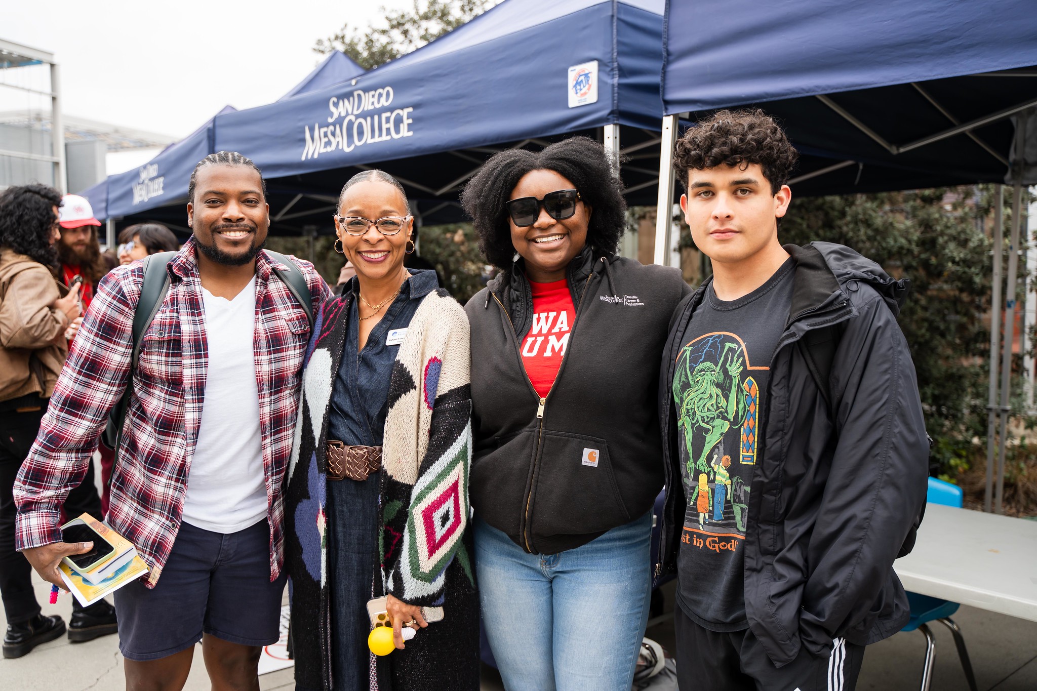 
Four people in front of a welcome week booth at Mesa College.
