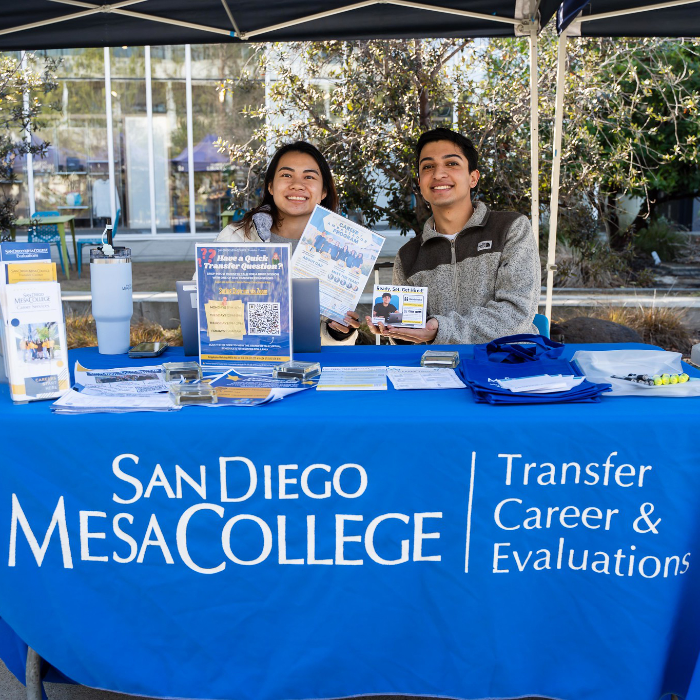 
Four people in front of a welcome week booth at Mesa College.
