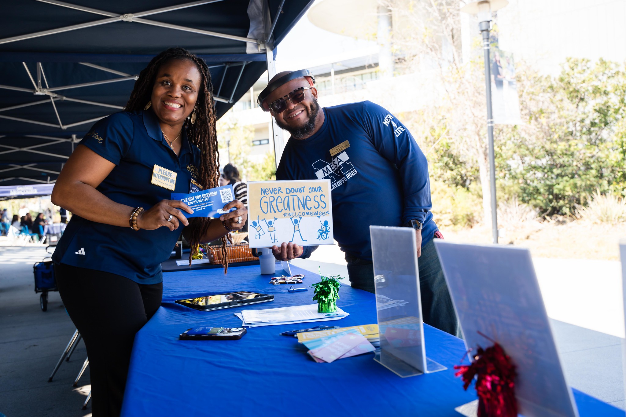 
Two people at a welcome week booth at Mesa College.
