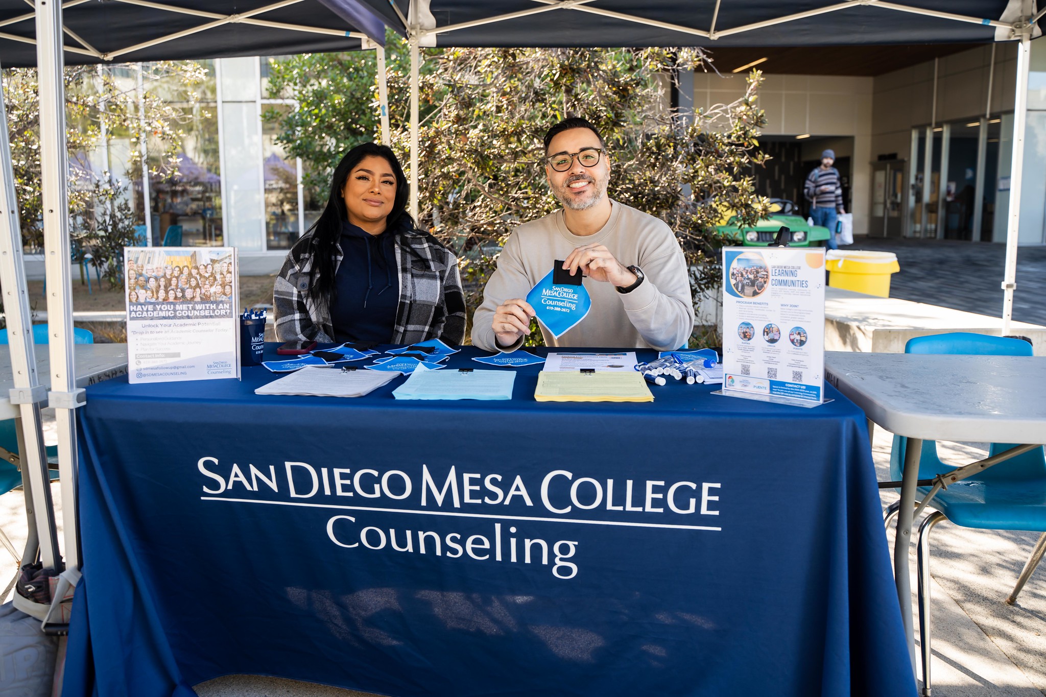 
Two people working the counseling booth at Mesa College.
