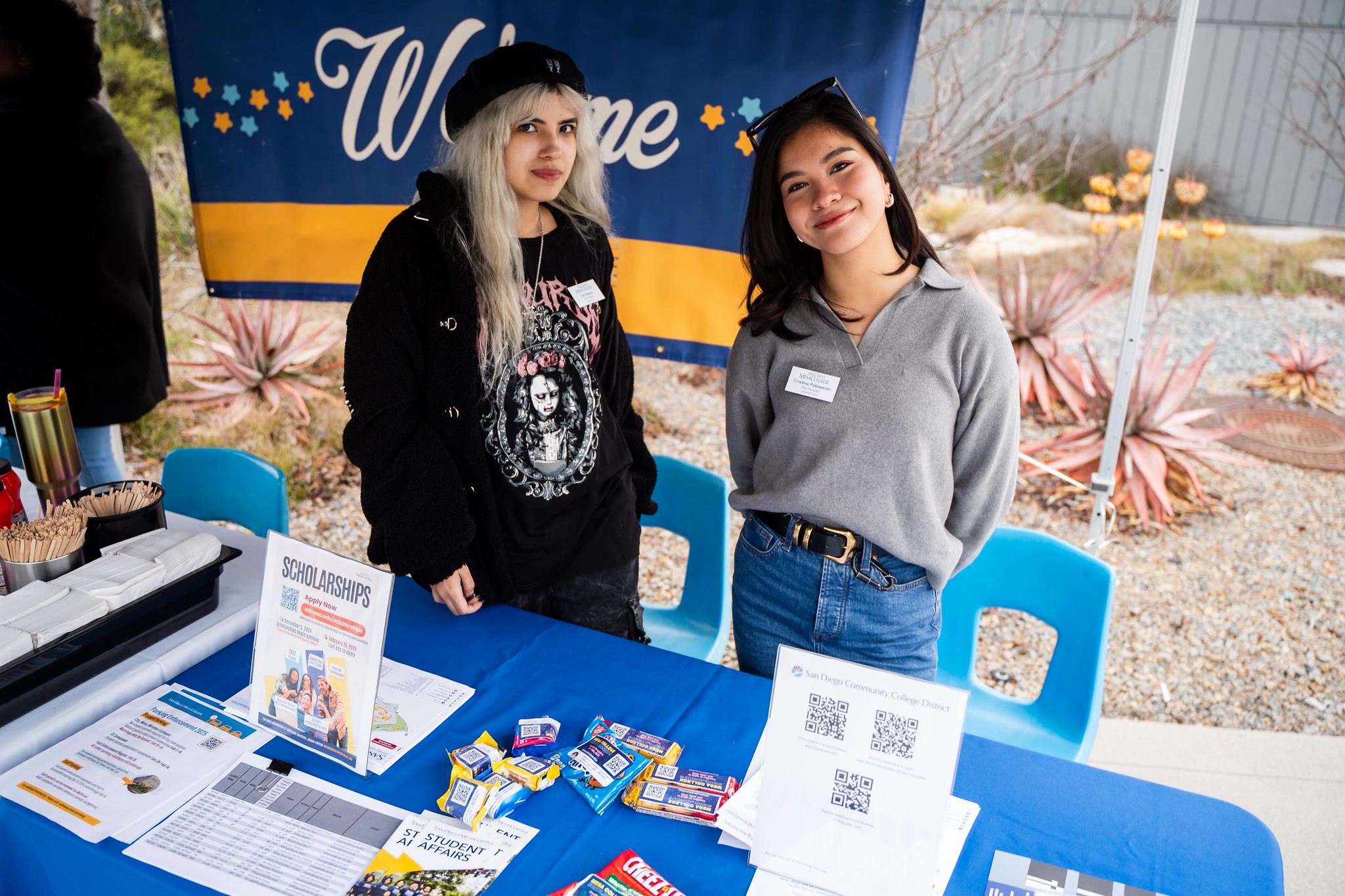 
Two ladies working at a welcome booth at Mesa College.
