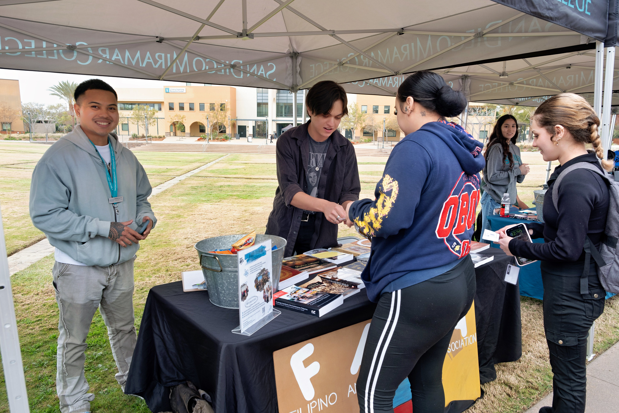 
Four people at Miramar welcome booth.
