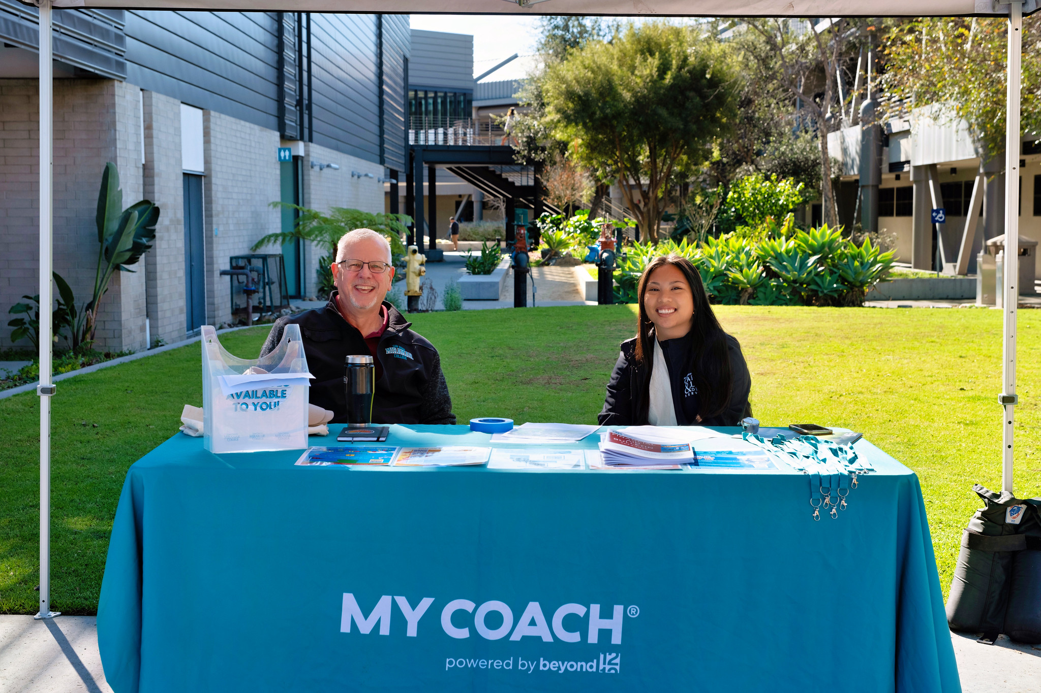 
Miramar College President Wes Lunburg at a welcome booth with an assistant.
