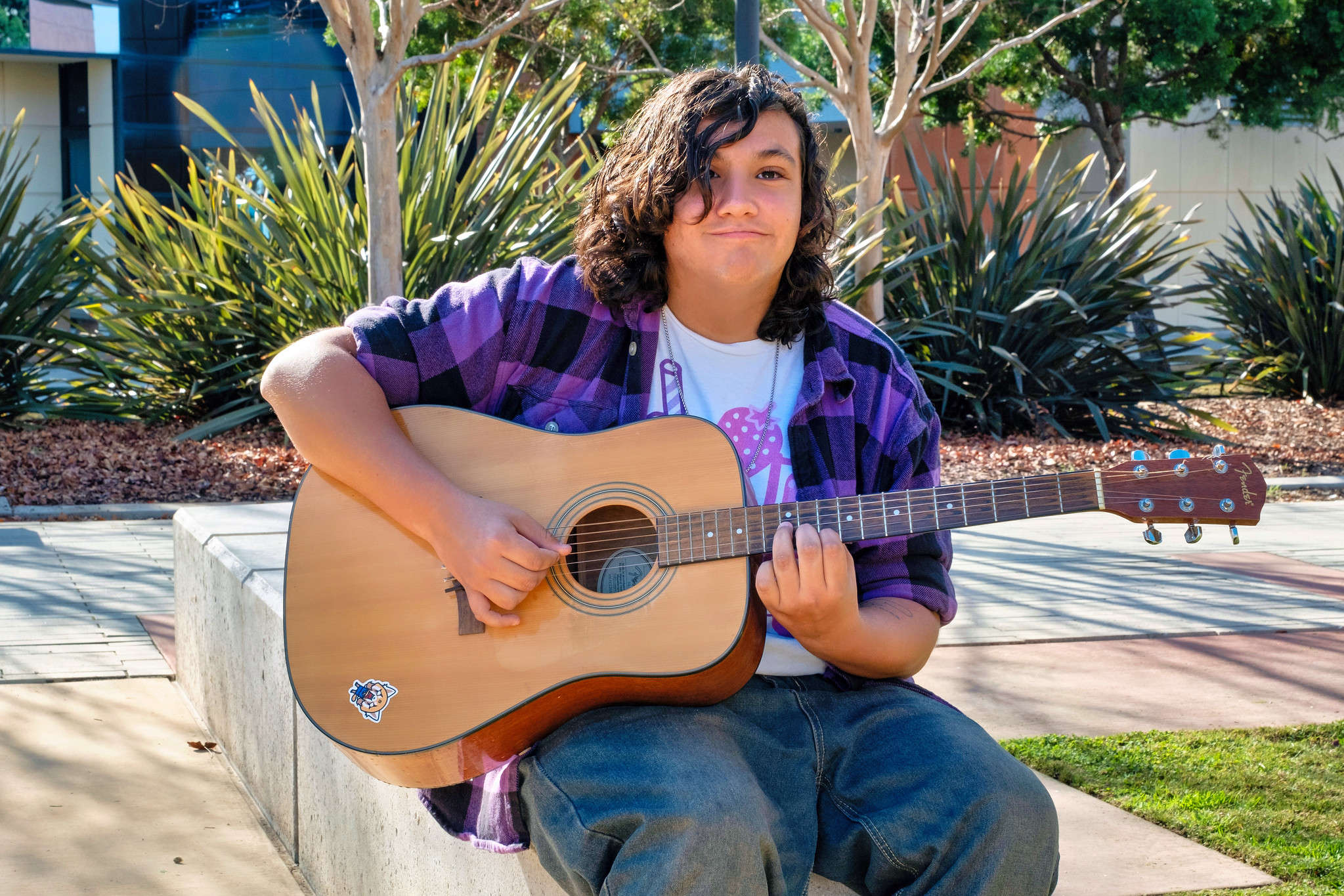 
A Miramar student playing a guitar.
