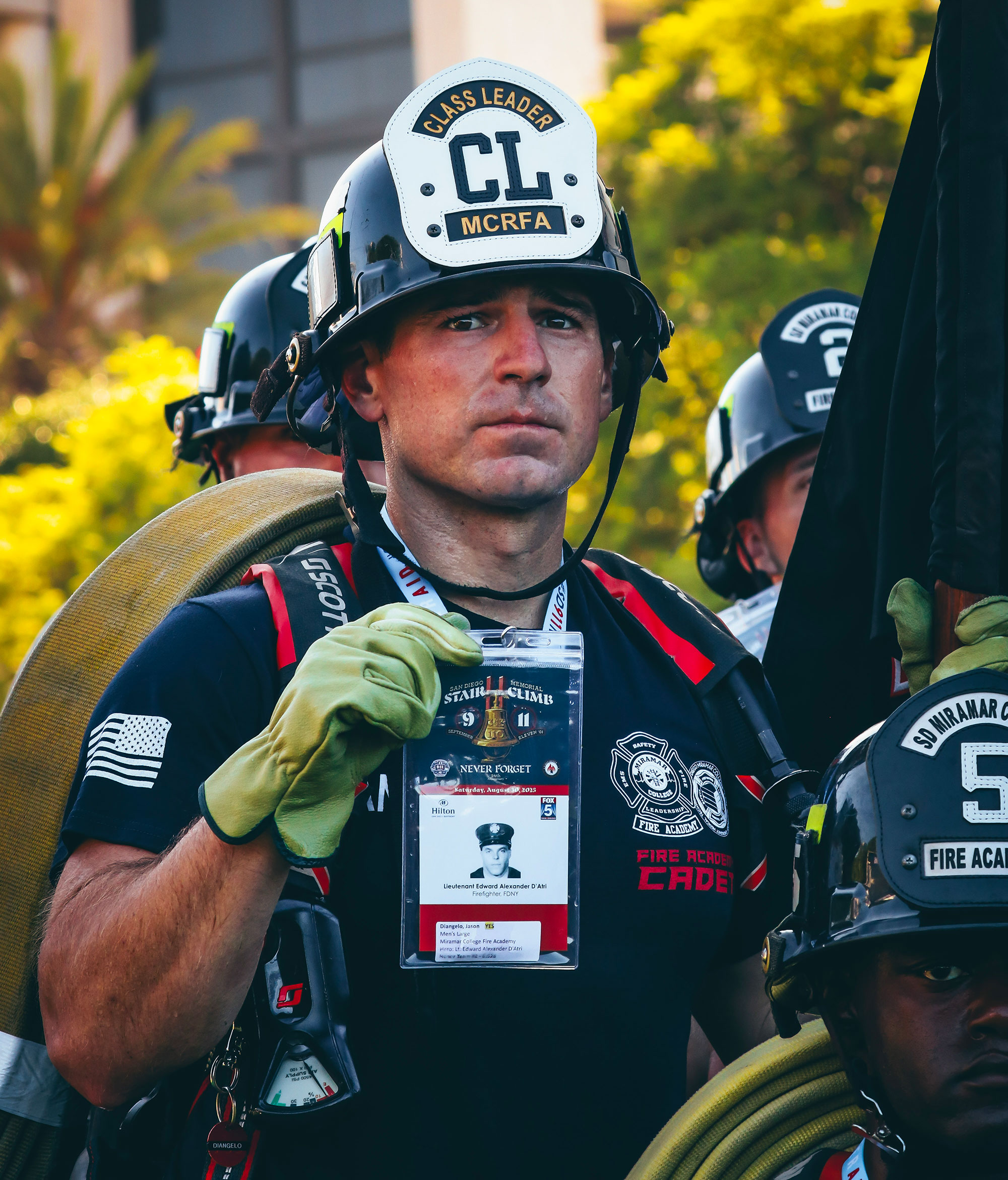 
An instructor with Miramar College's Fire Academy holds up a picture of the fallen firefighter he's walking for at the Memorial Stair Climb.
