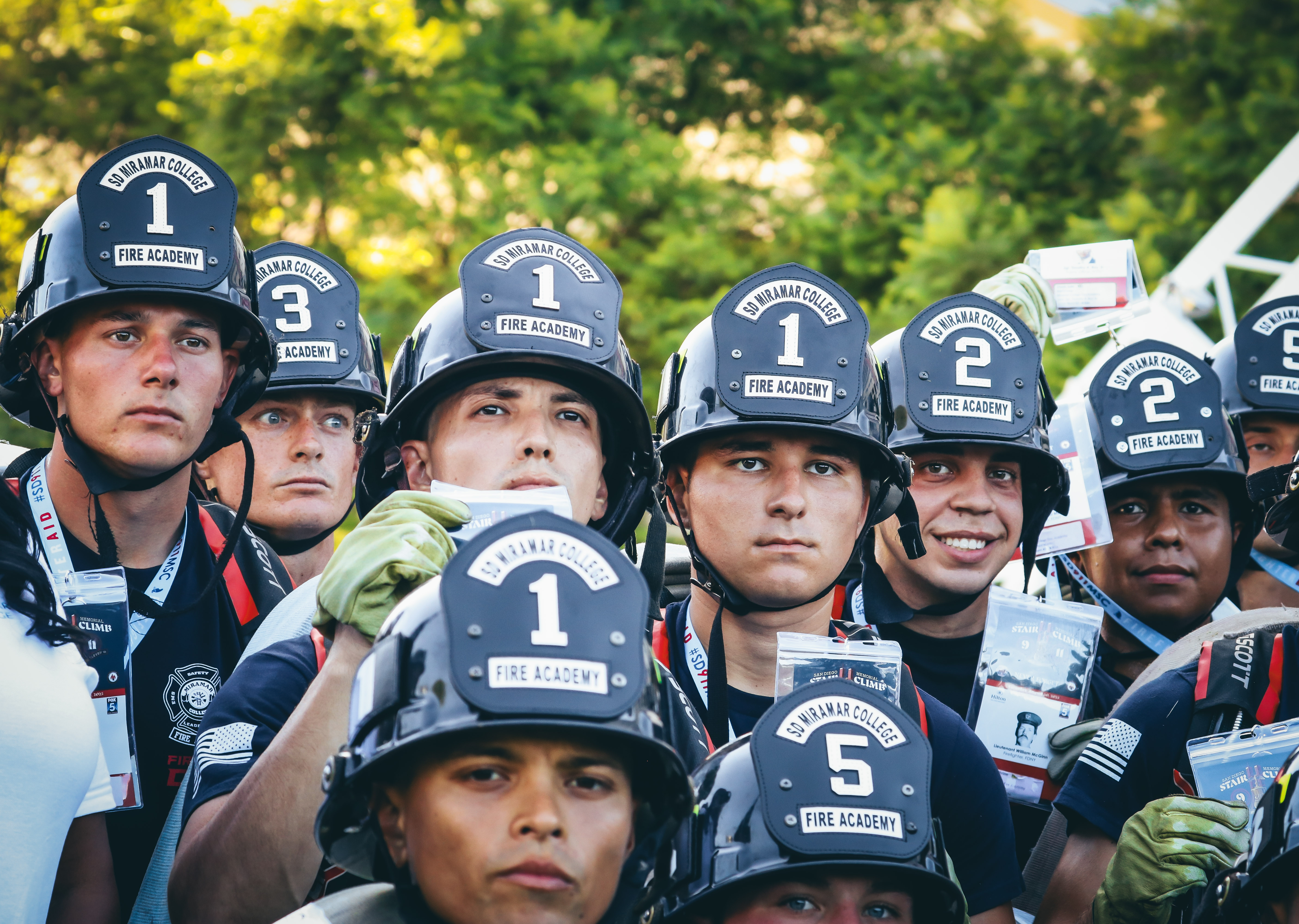 
Ten fire academy cadets hold up the pictures of the fallen firefighters they're walking for.
