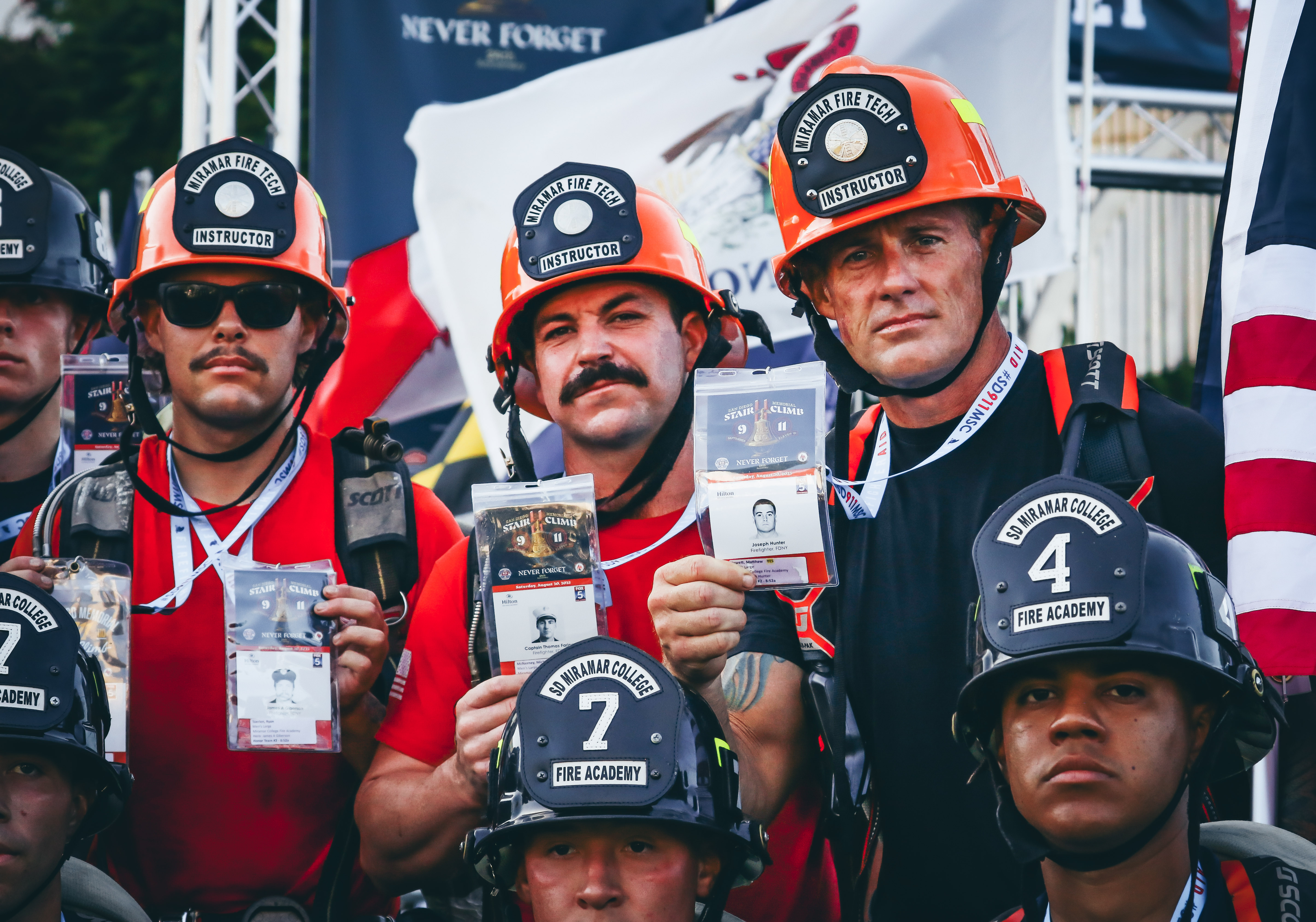 
Three fire academy instuctors hold up pictures of the fallen firefighters they are walking for.&nbsp;
