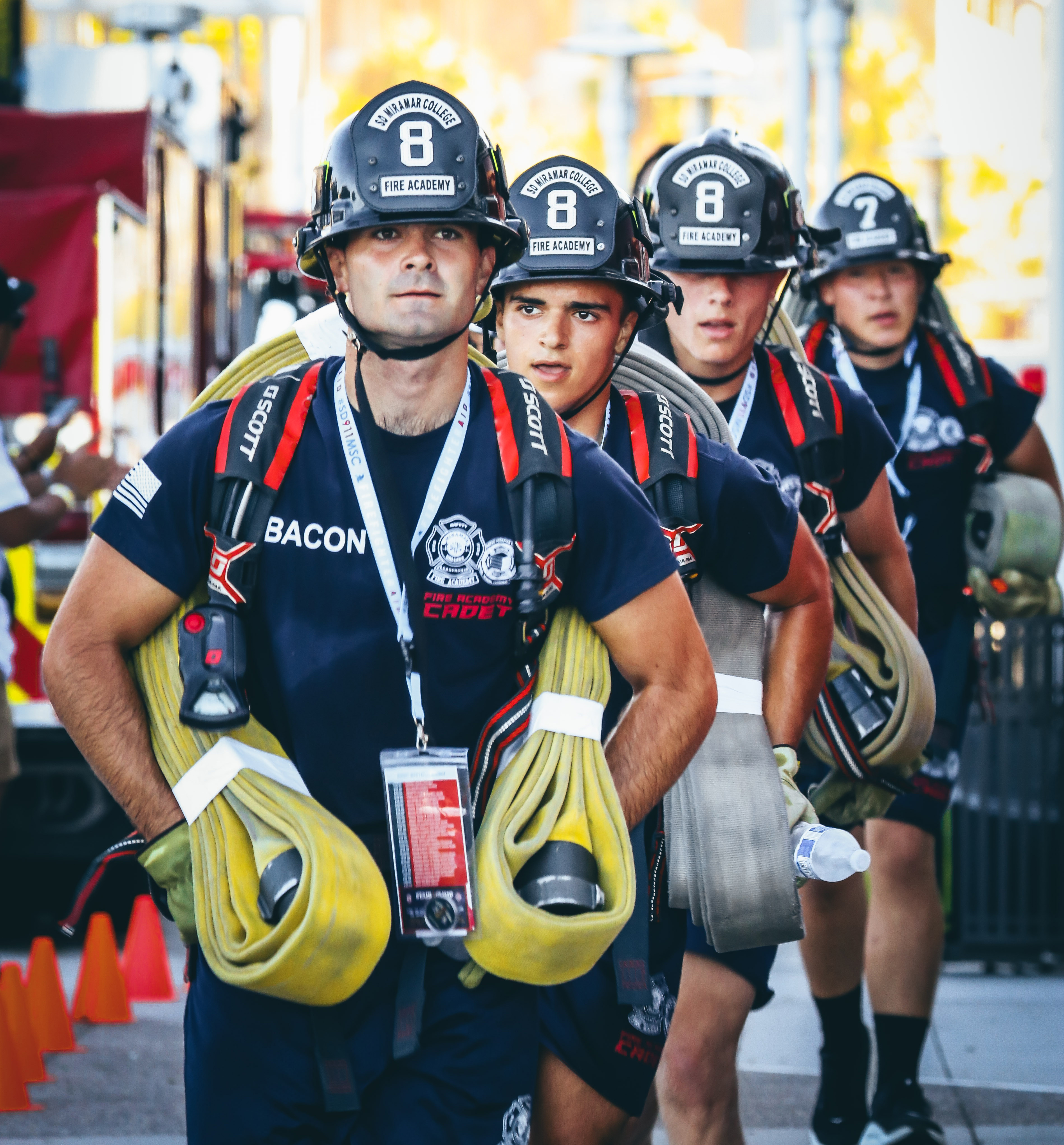 
Four men in fire helmets carry their fire gear in the stair climb.&nbsp;
