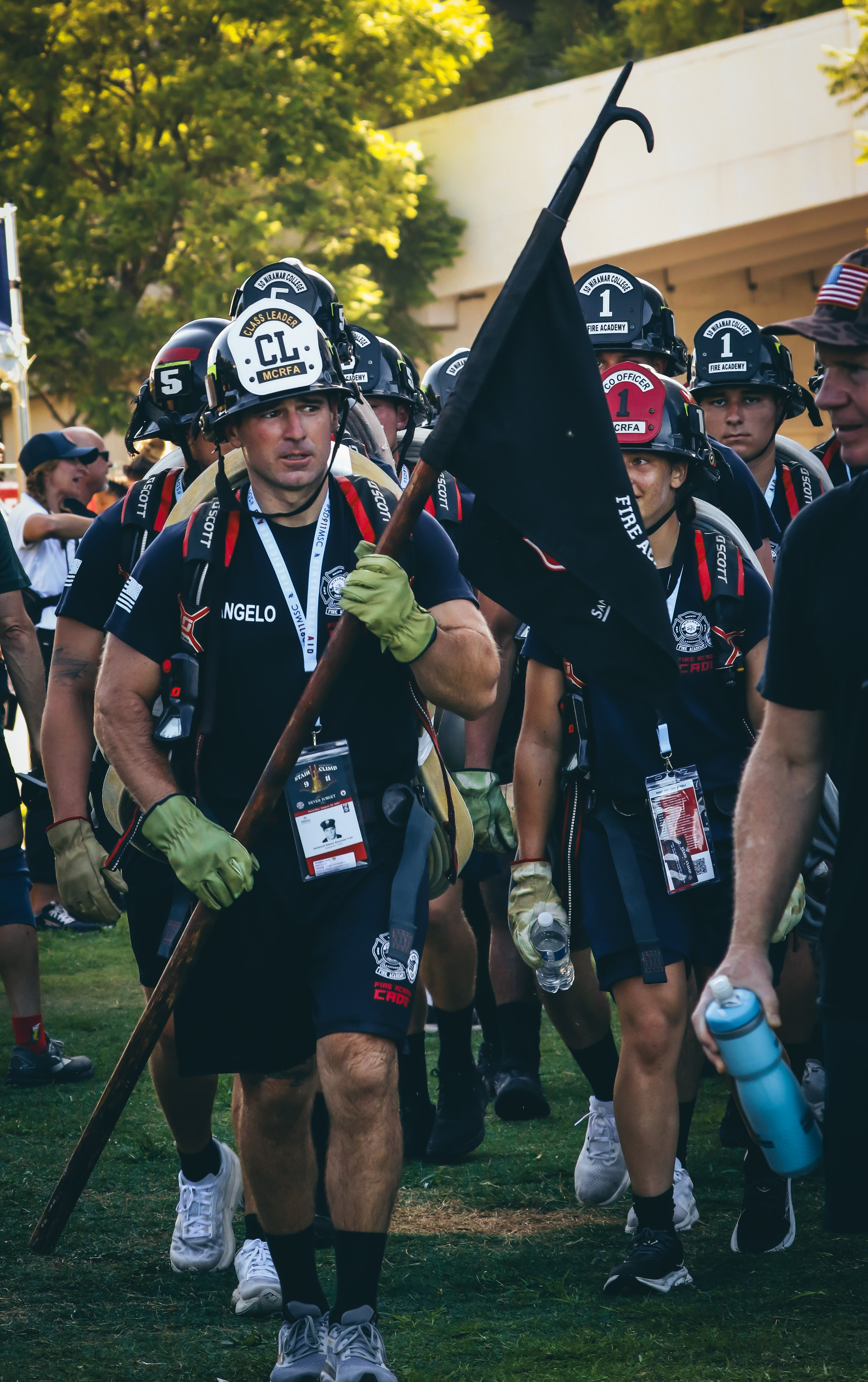 
A member of the fire academy holds a black flag as he walks in the stair climb.
