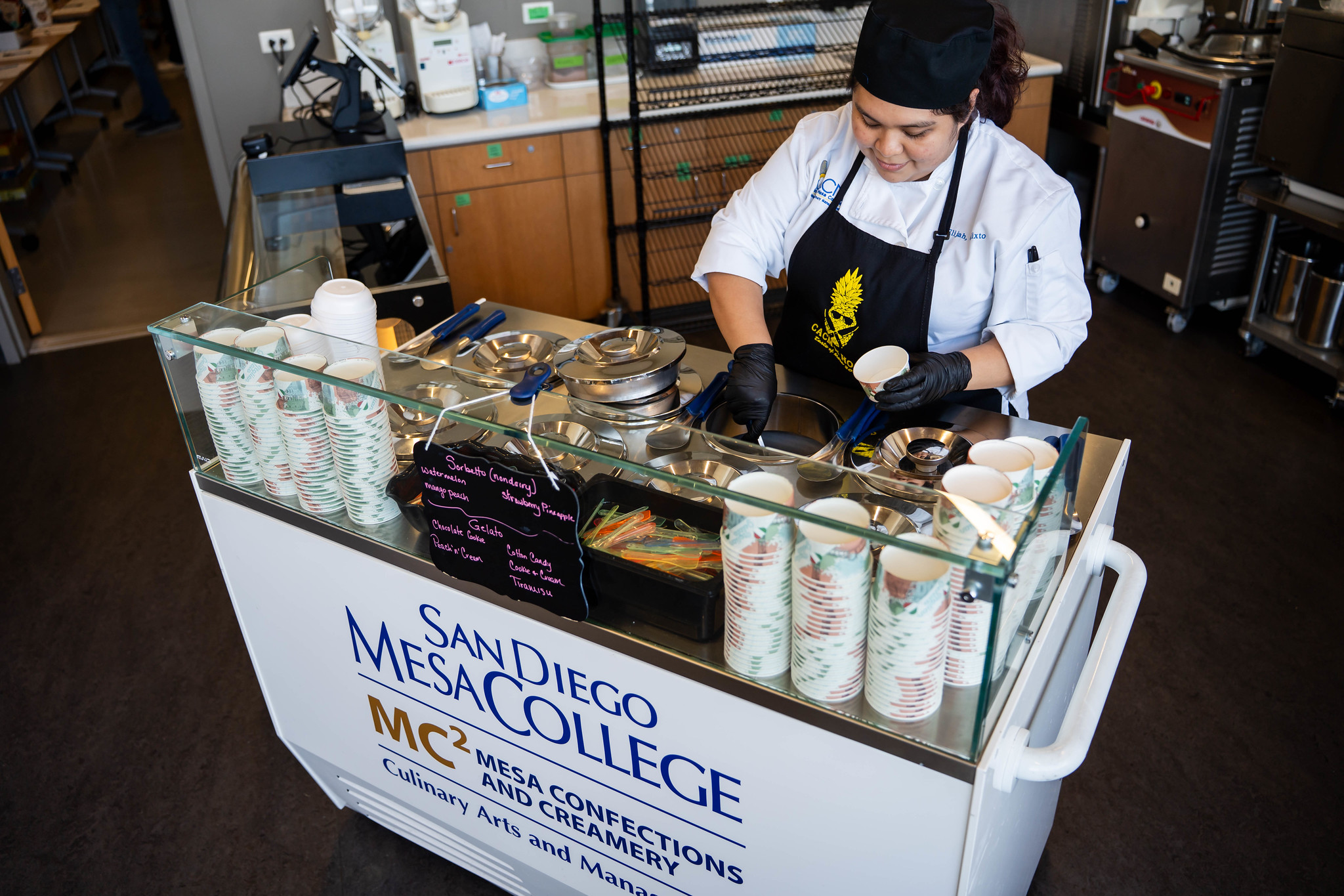 
A chef serves up sorbet at an ice cream cart.
