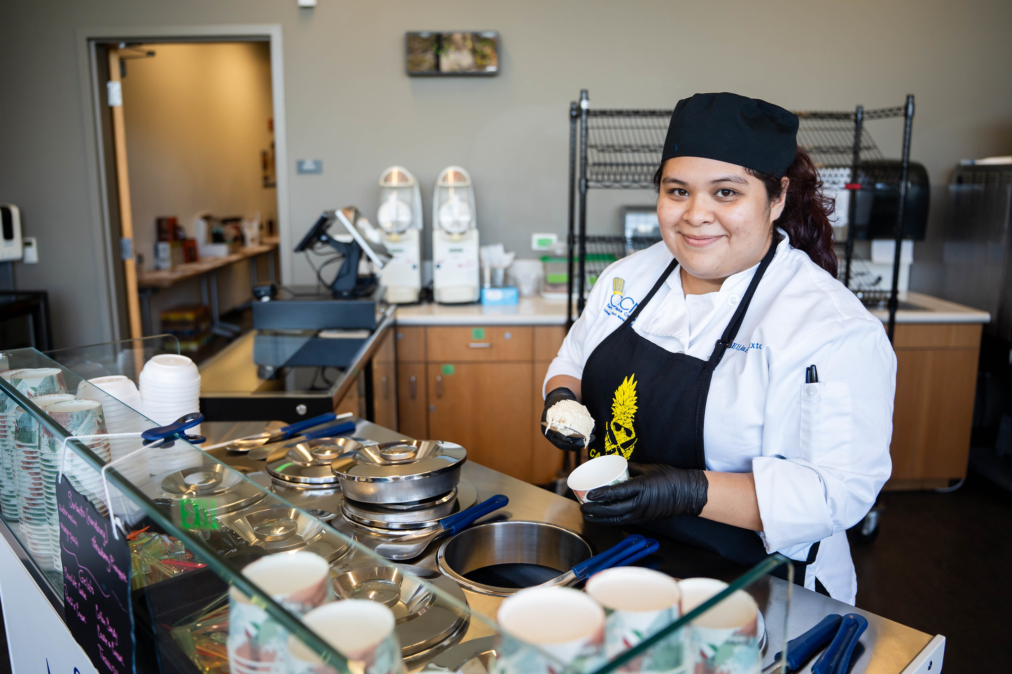 
A chef serves up sorbet at an ice cream cart.
