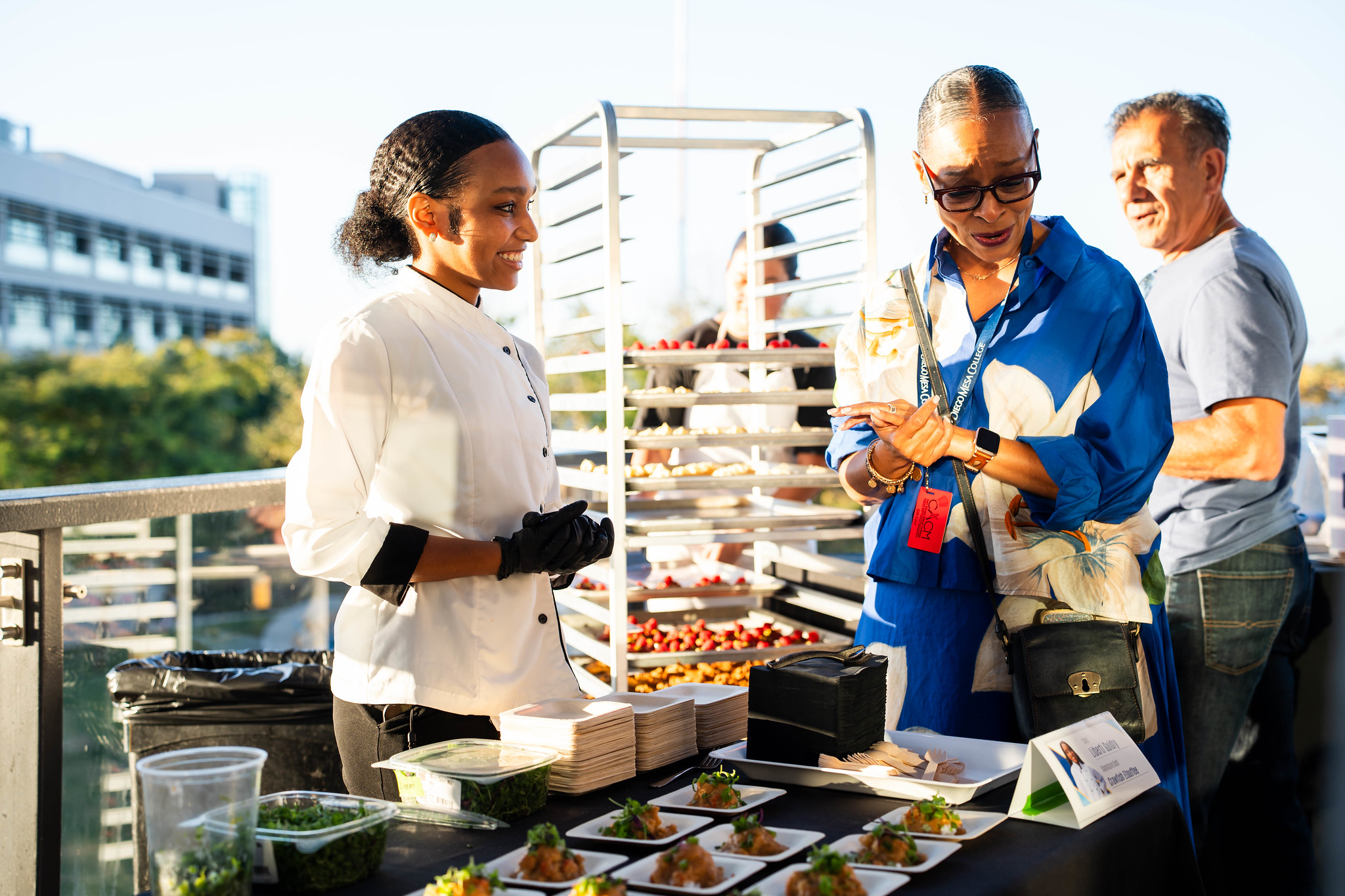 
A chef shows tasting samples to Mesa College President Ashanti Hands.
