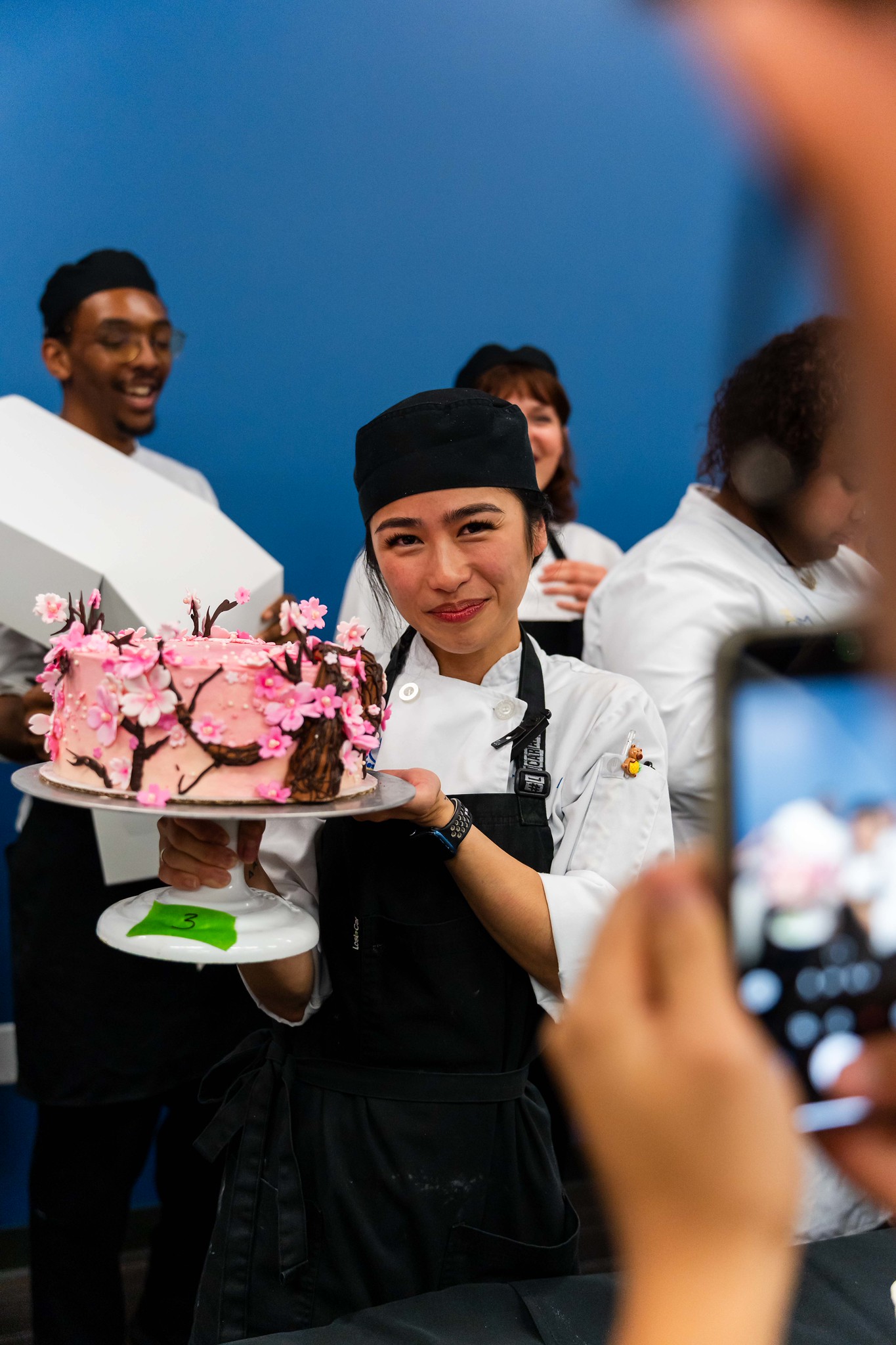 
Trisha Andres poses with her pink cherry blossom award-winning cake.
