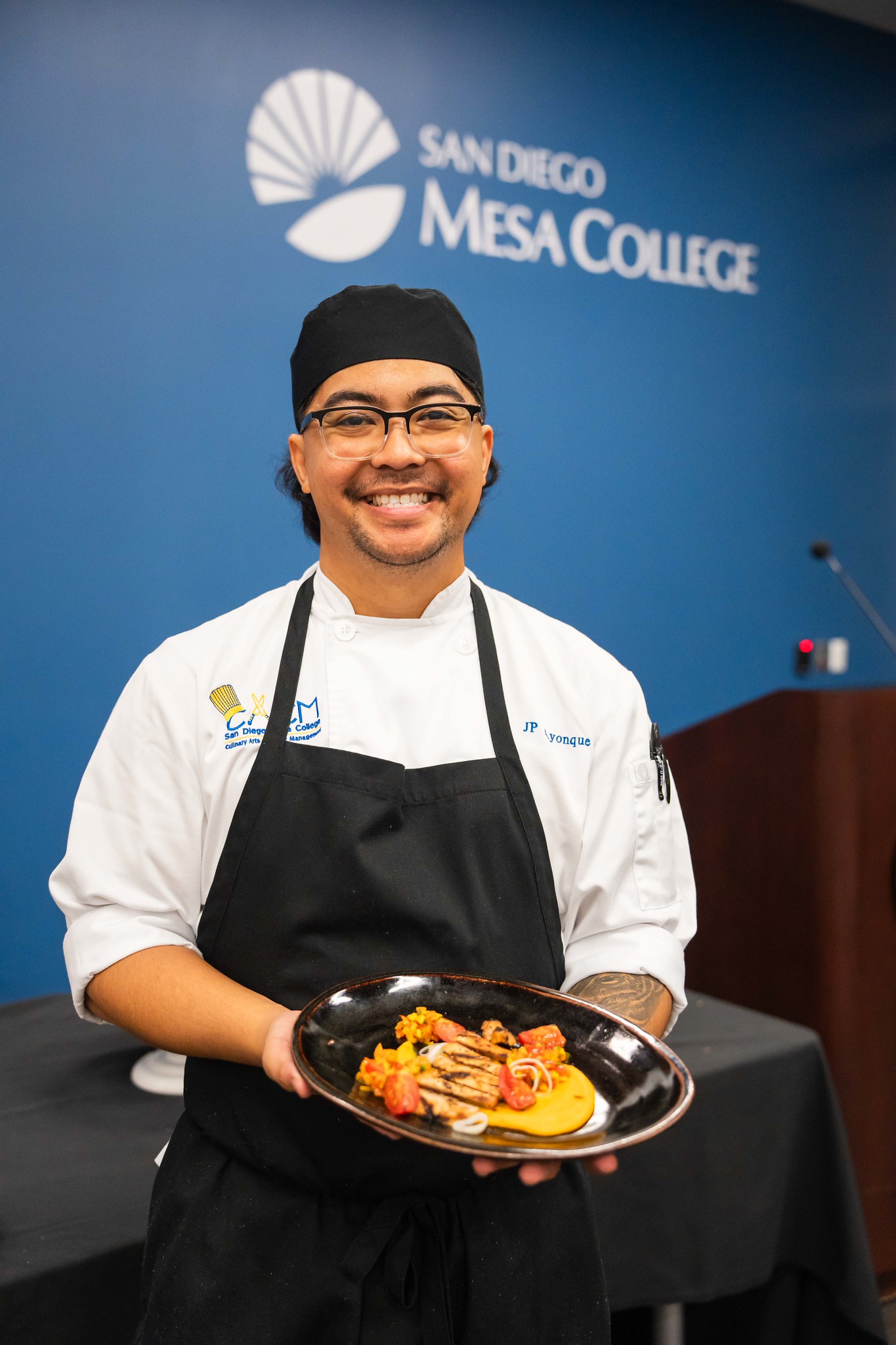 
A chef holds up his dish
