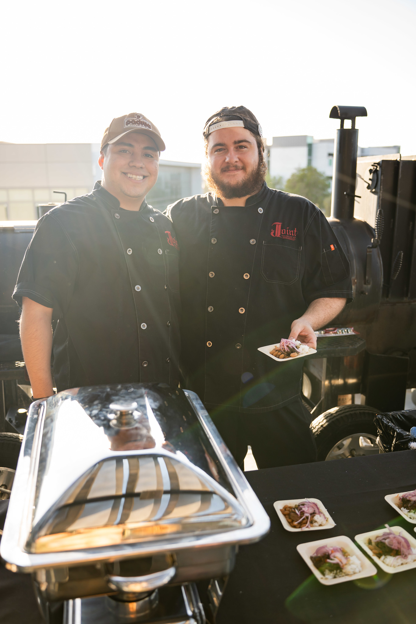 
Two chefs serving up samples.
